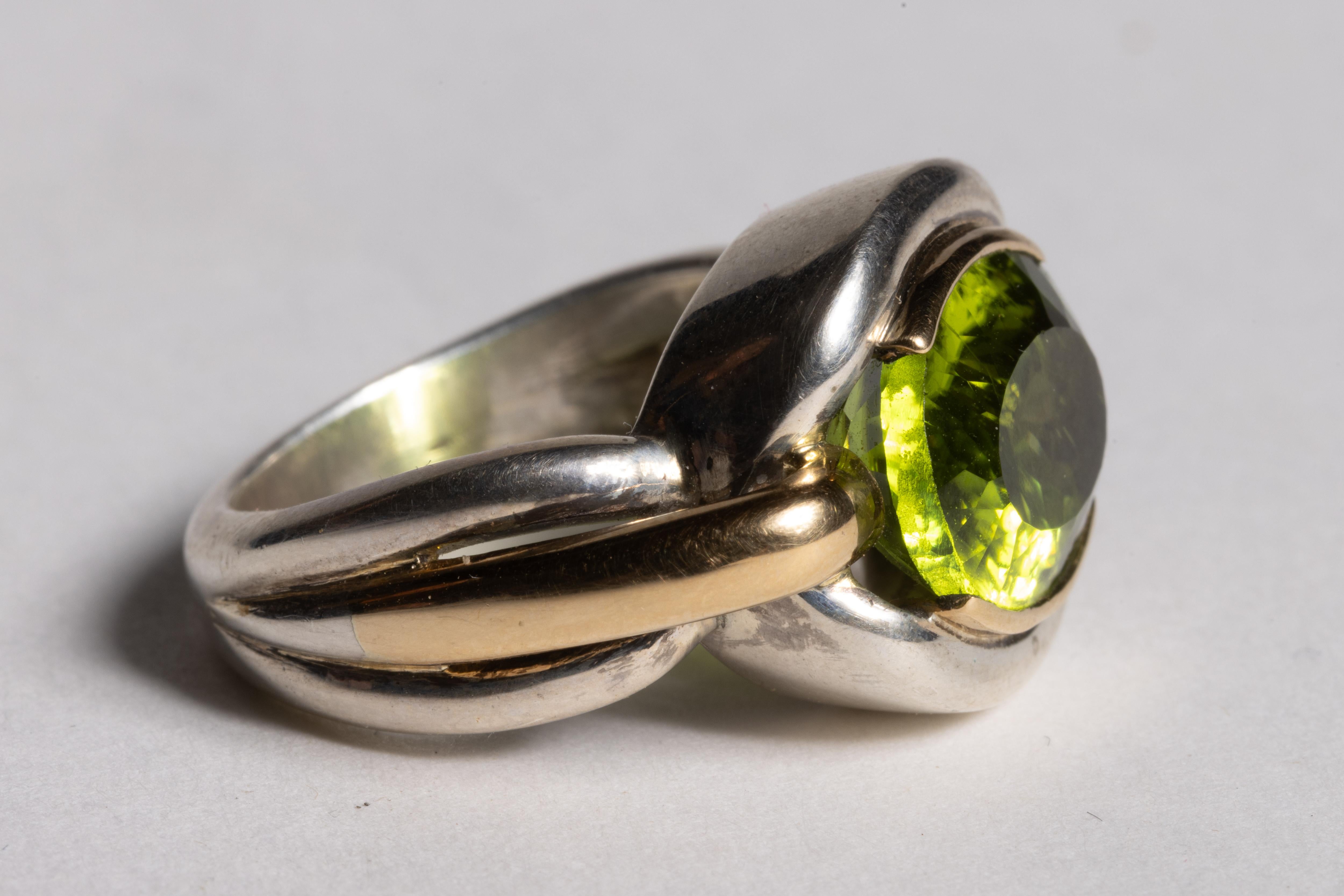 A brilliant 8 carat faceted oval peridot is the star of this stunning ring.  The ring itself is a combination of 18K gold and sterling silver.  Not a plated gold, but a weighted gold.  Ring size is 7.

The fine jewelry collection is sourced,