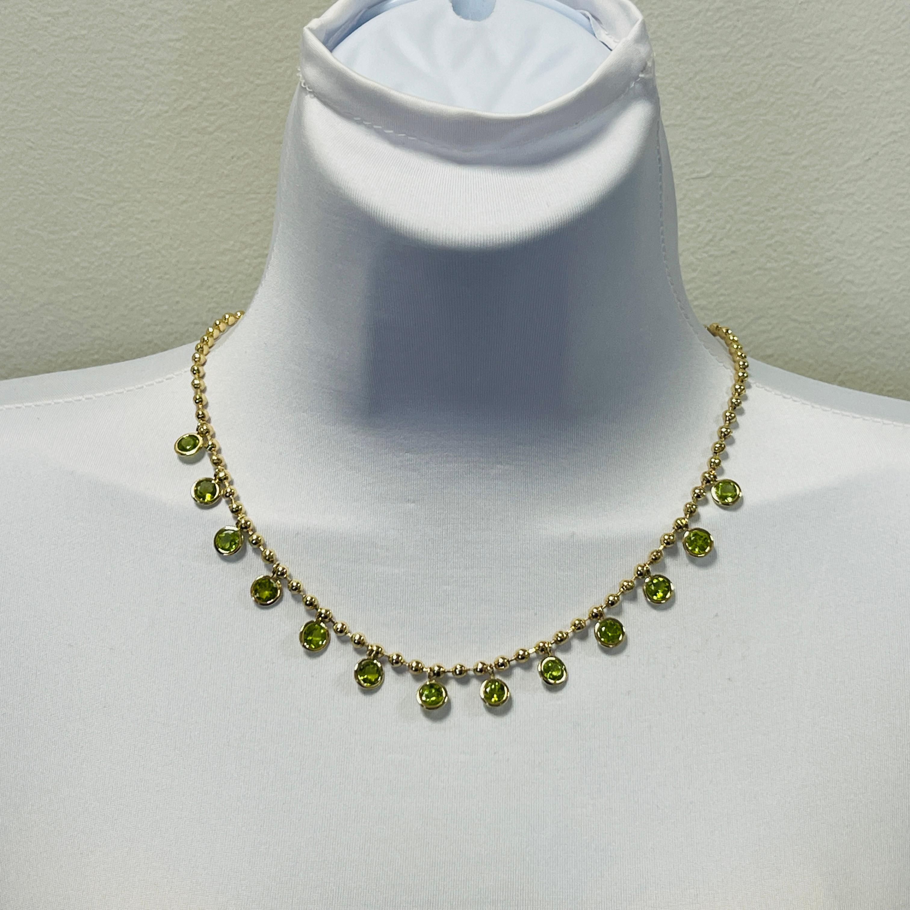 Beautiful 11.39 ct. round peridots.  Handmade in 18k yellow gold.  Length is 18.25