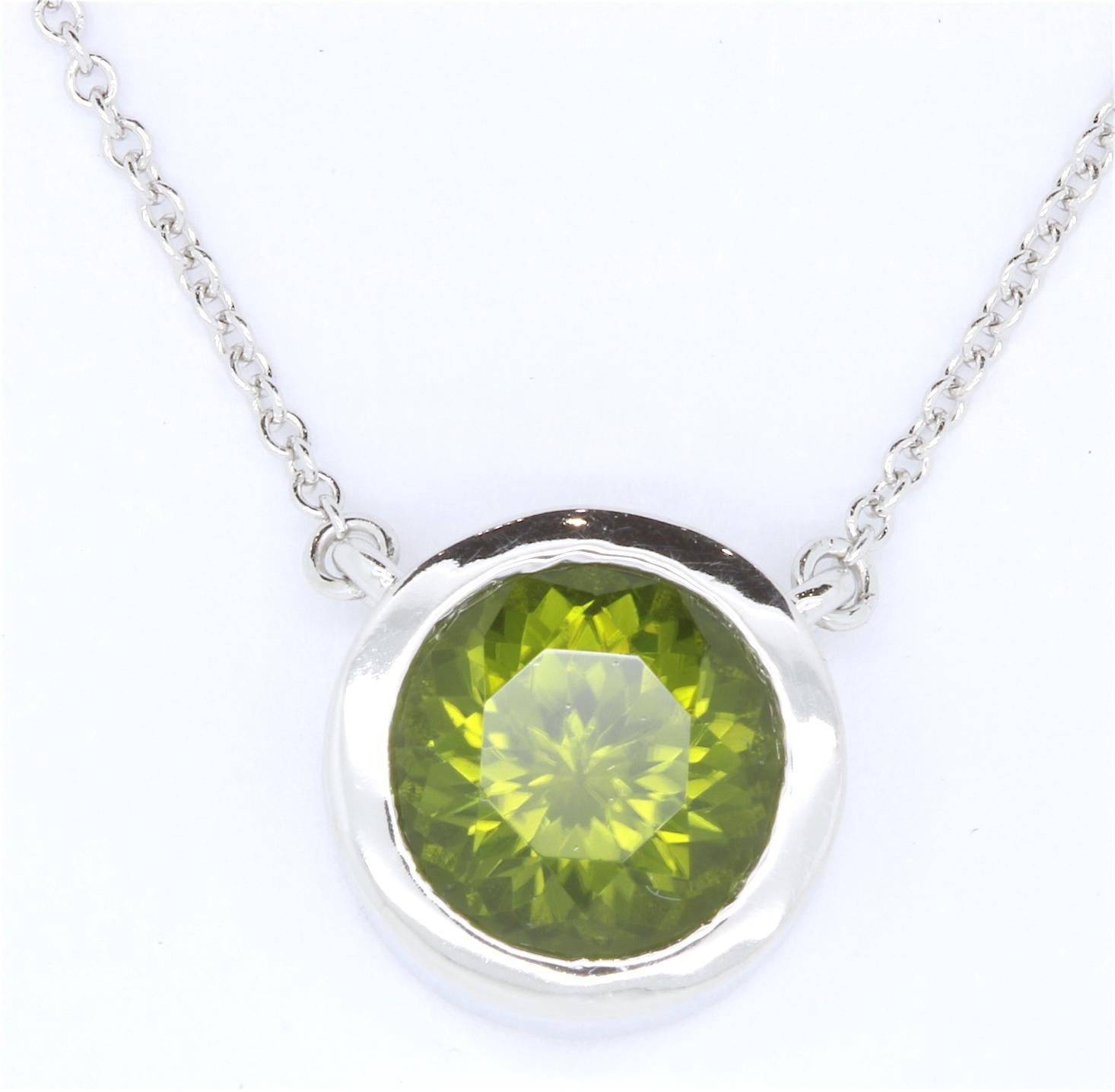 Simple and Stunning, this 3.19 carat Peridot stone is set in a 14K White Gold Bezel setting.

Material: 14k White Gold
Center Stone Details: 3.19 Carat Peridot 
Chain: 18 inches

Fine one-of-a-kind craftsmanship meets incredible quality in this