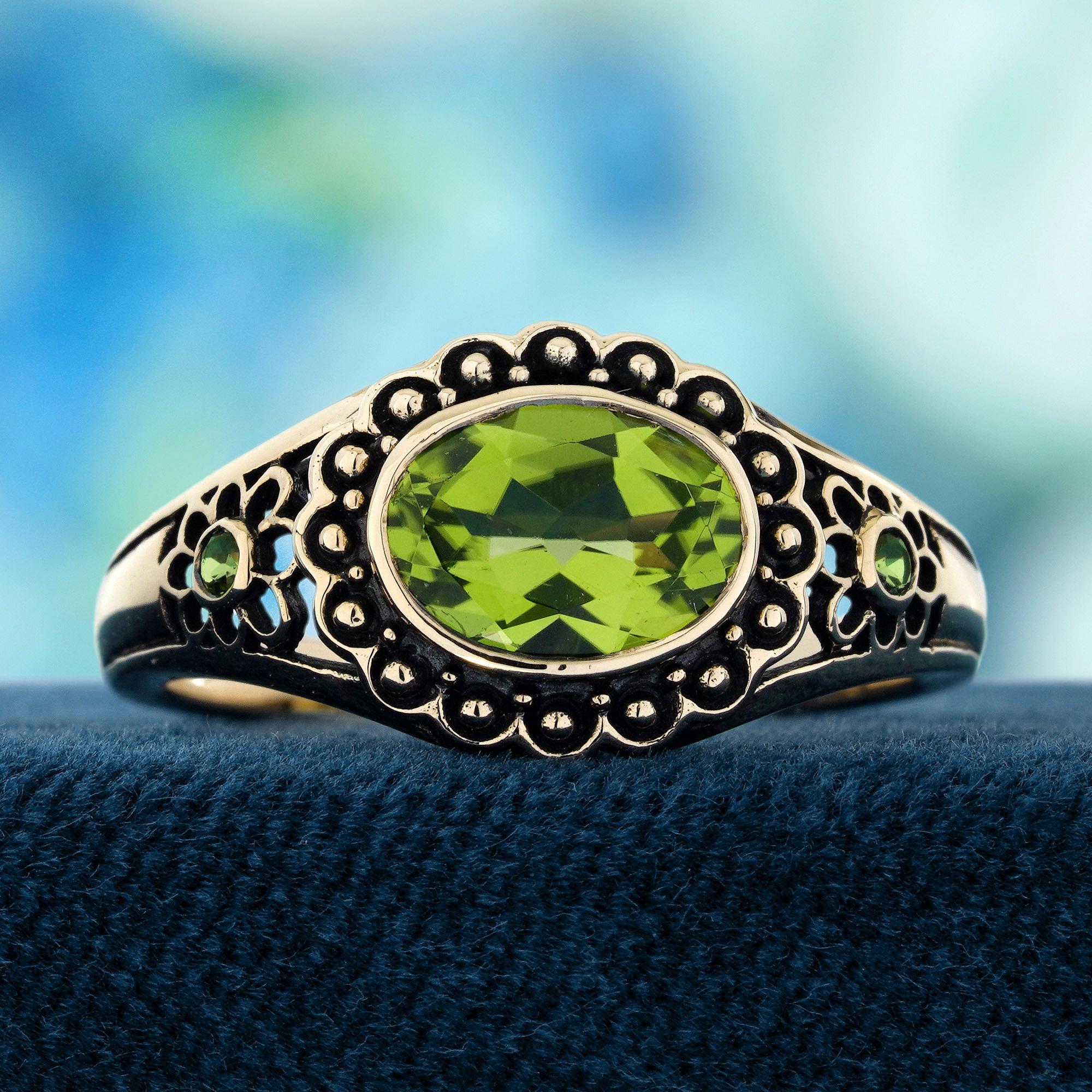 A  vibrant peridot set in a bezel at the center, beautifully designed to resemble the heart of a flower. The floral motif around the peridot adds intricate detailing, enhancing the ring's vintage charm. The rich green hue of the peridot, combined