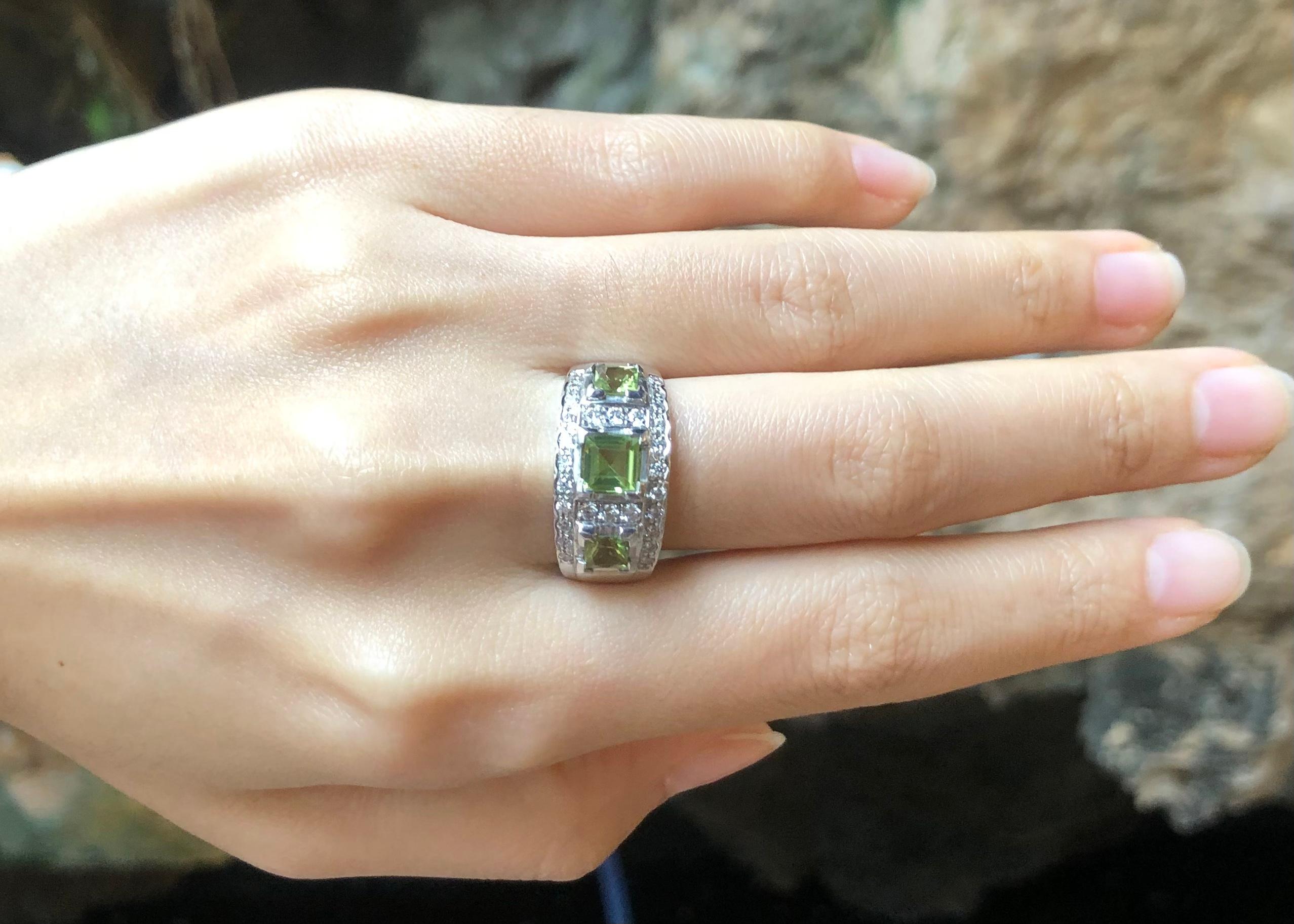 Peridot with Cubic Zirconia Ring set in Silver Settings

Width:  1.9 cm 
Length: 1.0 cm
Ring Size: 58
Total Weight: 6.04 grams

*Please note that the silver setting is plated with rhodium to promote shine and help prevent oxidation.  However, with
