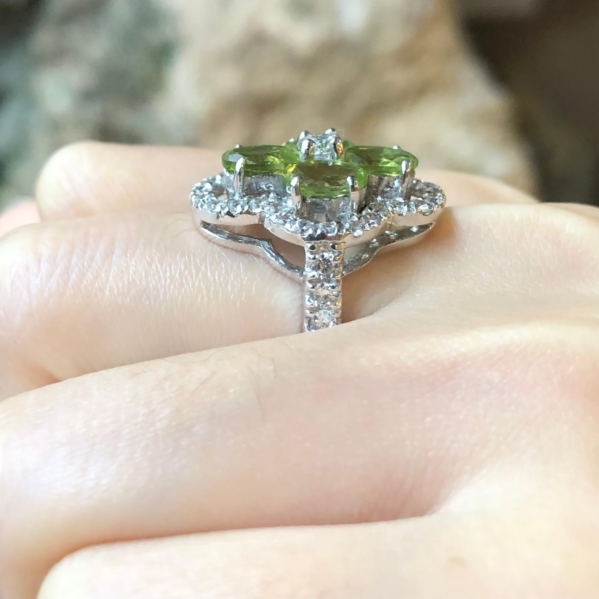 Peridot with Cubic Zirconia Ring set in Silver Settings

Width:  0.7 cm 
Length: 2.3 cm
Ring Size: 56
Total Weight: 6.56 grams

*Please note that the silver setting is plated with rhodium to promote shine and help prevent oxidation.  However, with