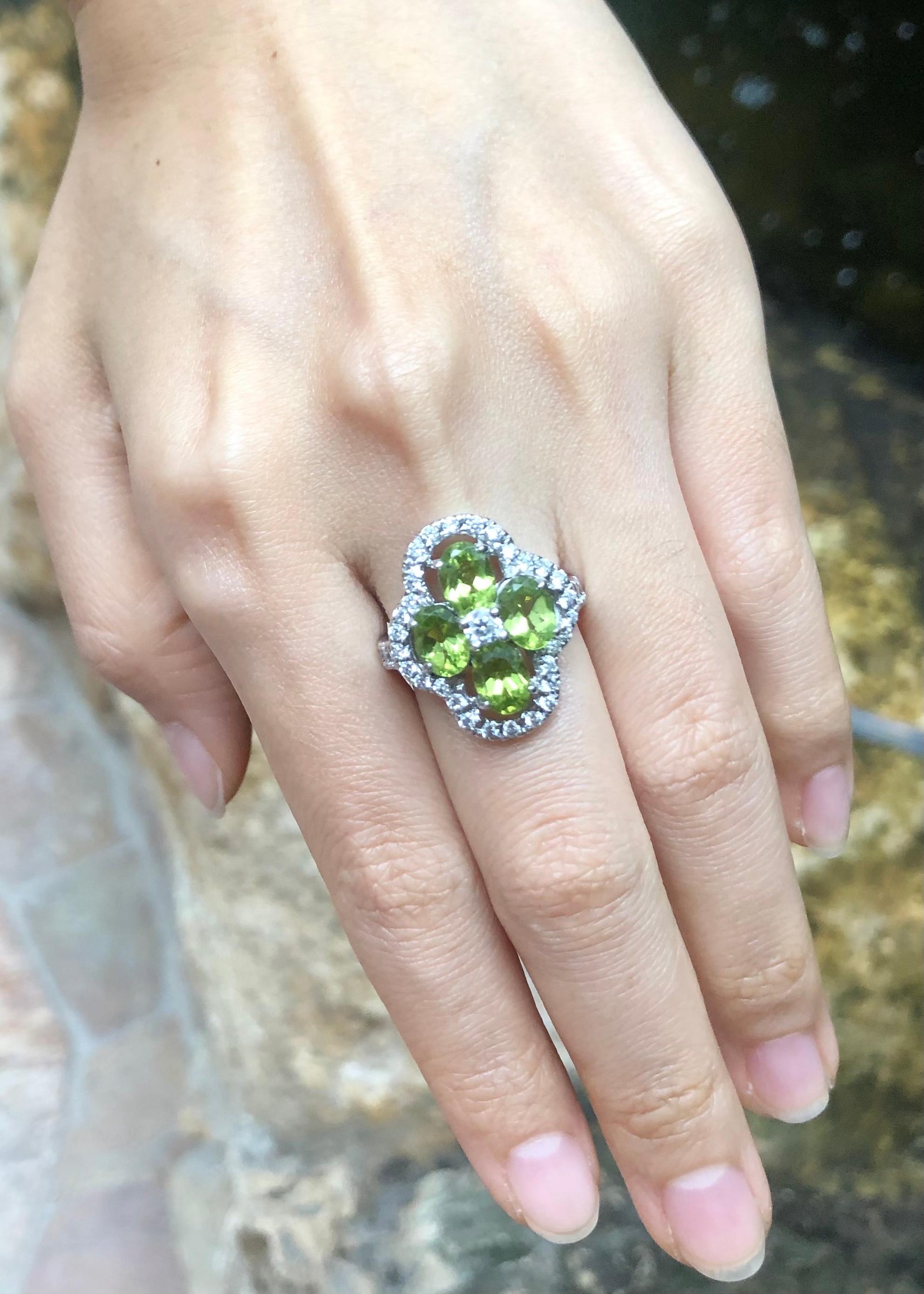 Oval Cut Peridot with Cubic Zirconia Ring set in Silver Settings For Sale