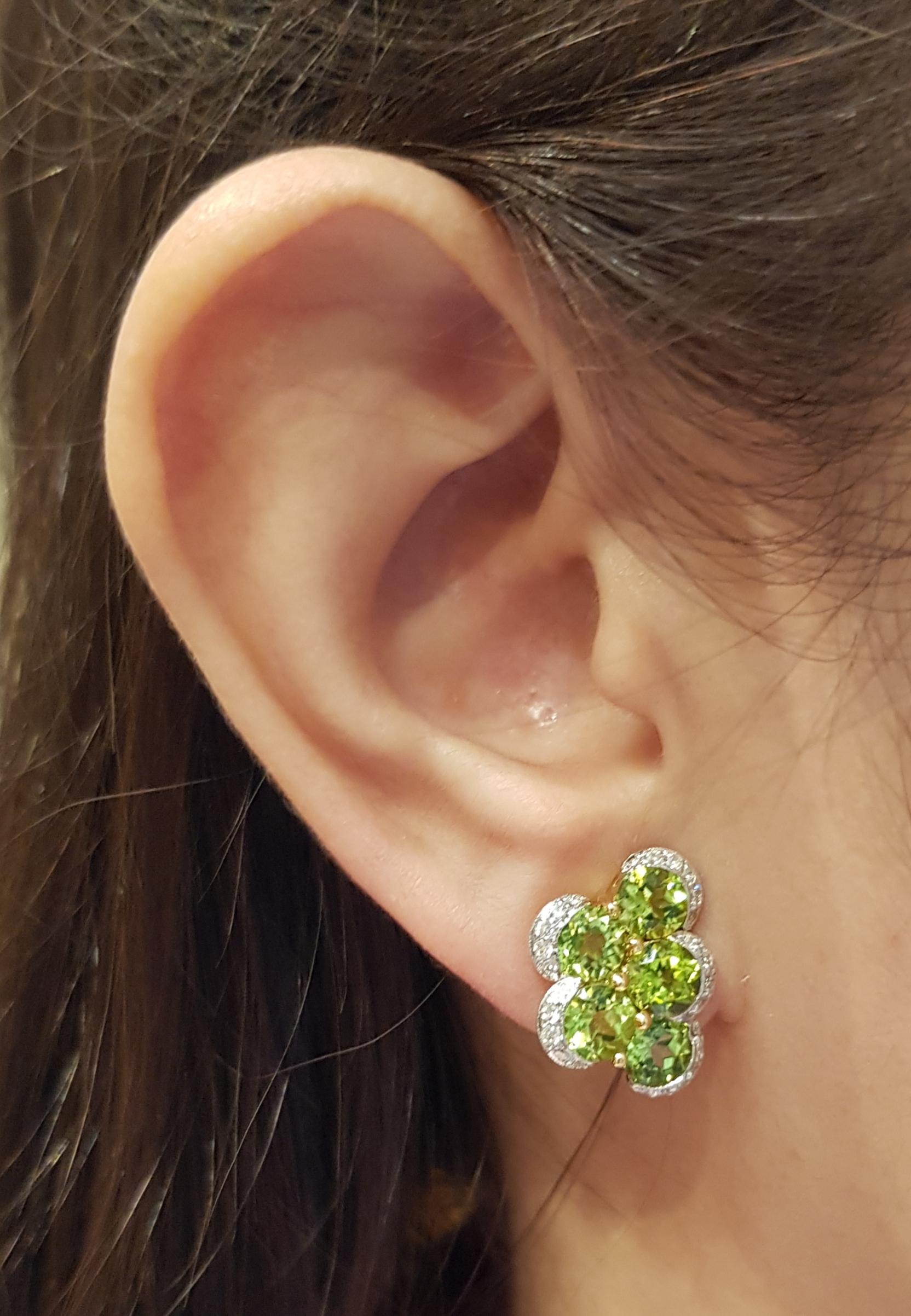 Peridot 6.47 carats with Diamond 0.44 carat Earrings set in 18 Karat Gold Settings

Width:  1.6 cm 
Length: 1.8 cm
Total Weight: 8.36grams

