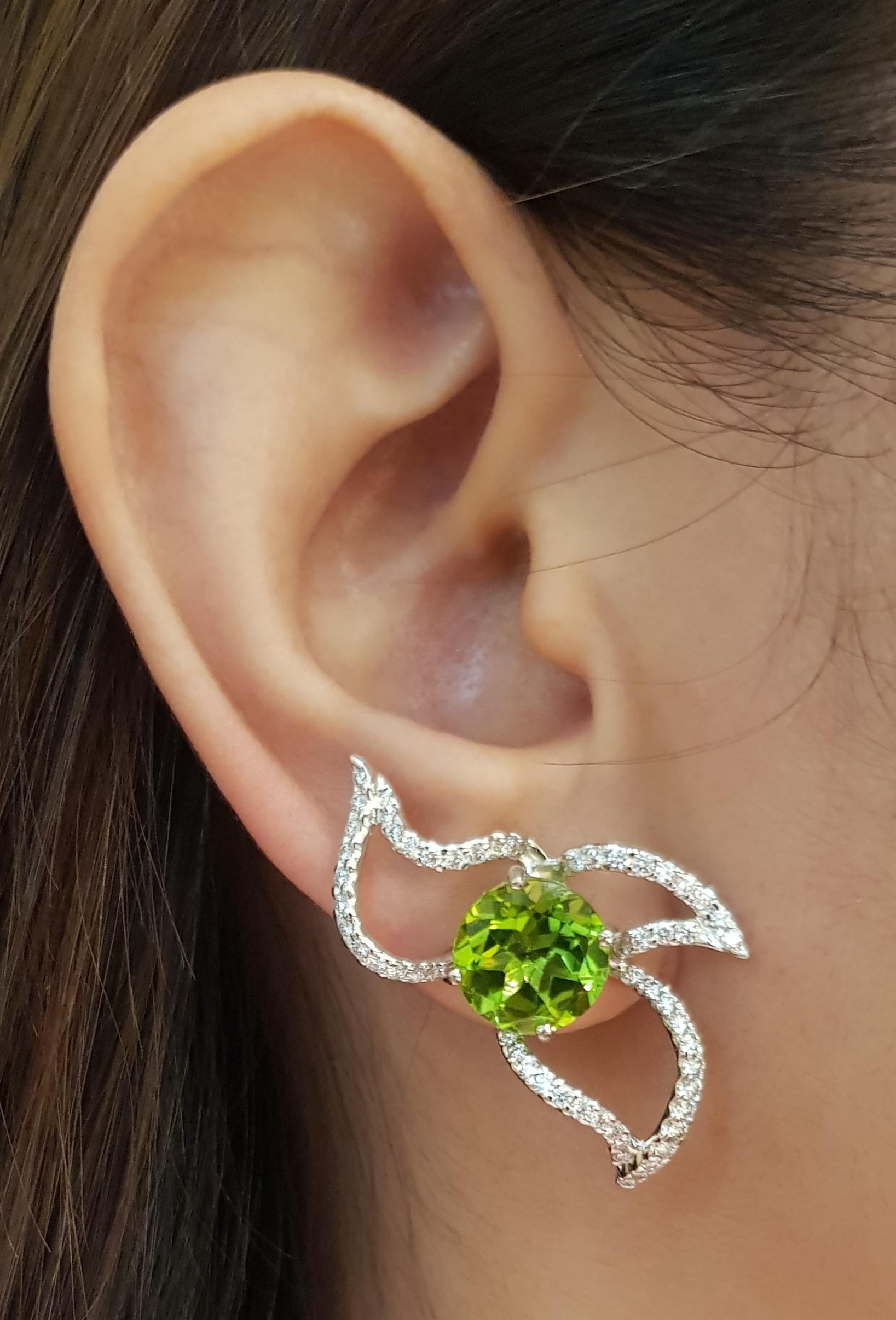 Peridot 8.50 carats with Diamond 1.24 carats Earrings set in 18 Karat White Gold Settings

Width:  2.1 cm 
Length:  3.4 cm
Total Weight: 9.62 grams

