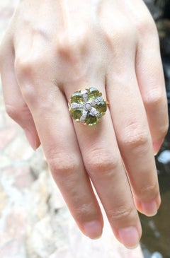 Peridot with Diamond Ring Set in 14 Karat Gold Settings