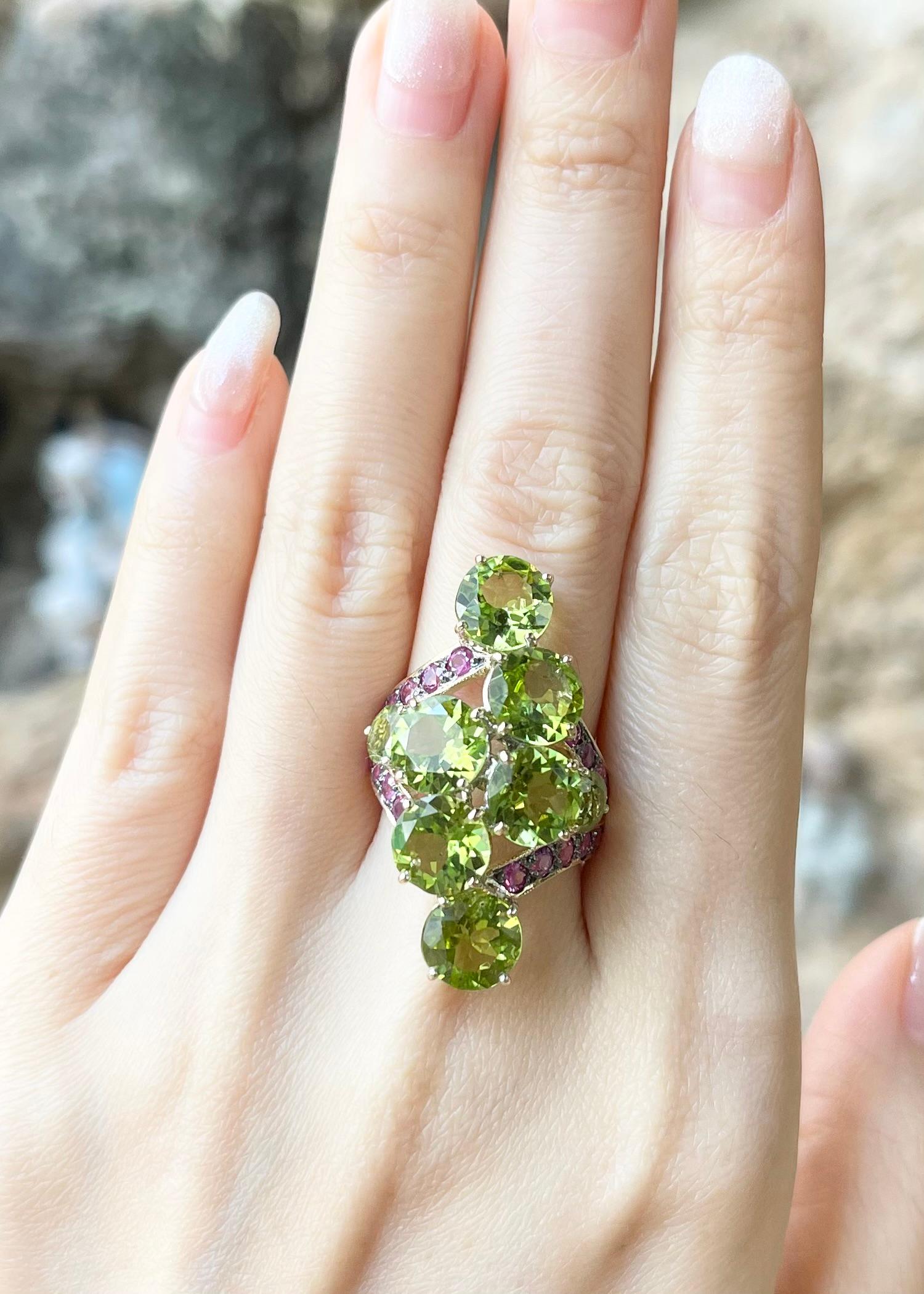 Peridot 11.37 carats with Pink Sapphire 1.35 carats Ring set in 18K Gold Settings

Width:  2.0 cm 
Length: 3.4 cm
Ring Size: 53
Total Weight: 12.03 grams


