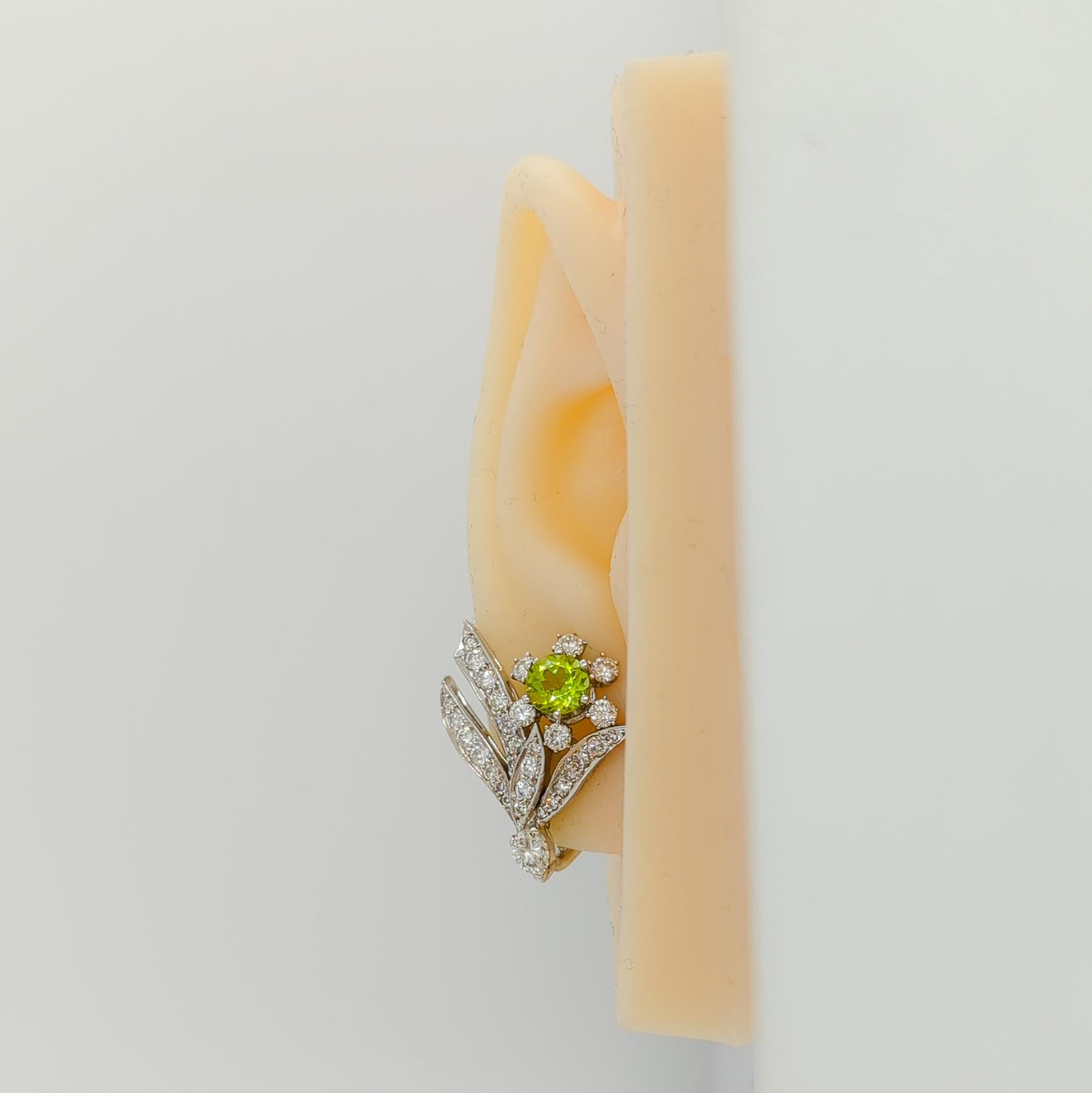 Beautiful earrings with 1.25 ct. peridot rounds, good quality white diamond rounds, and marquises.  Handmade in platinum.  These flower earrings are a great addition to any fine jewelry collection.