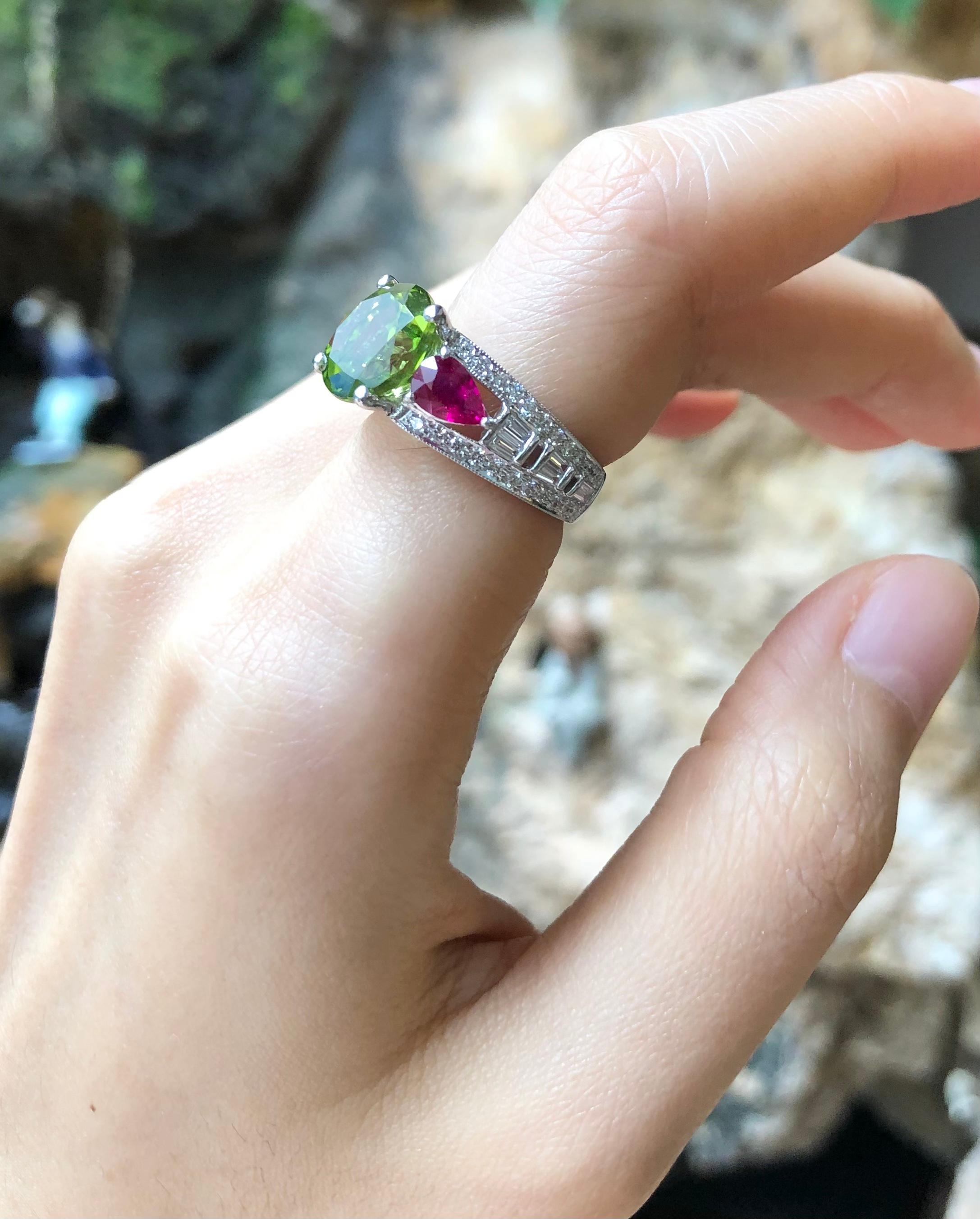Peridot 4.26 carats with Ruby 1.10 carats and Diamond 0.70 carat Ring set in 18 Karat White Gold Settings

Width:  2.0 cm 
Length:  1.0 cm
Ring Size: 49
Total Weight: 6.88 grams

Peridot
Width:  1.0 cm 
Length:  1.0 cm

