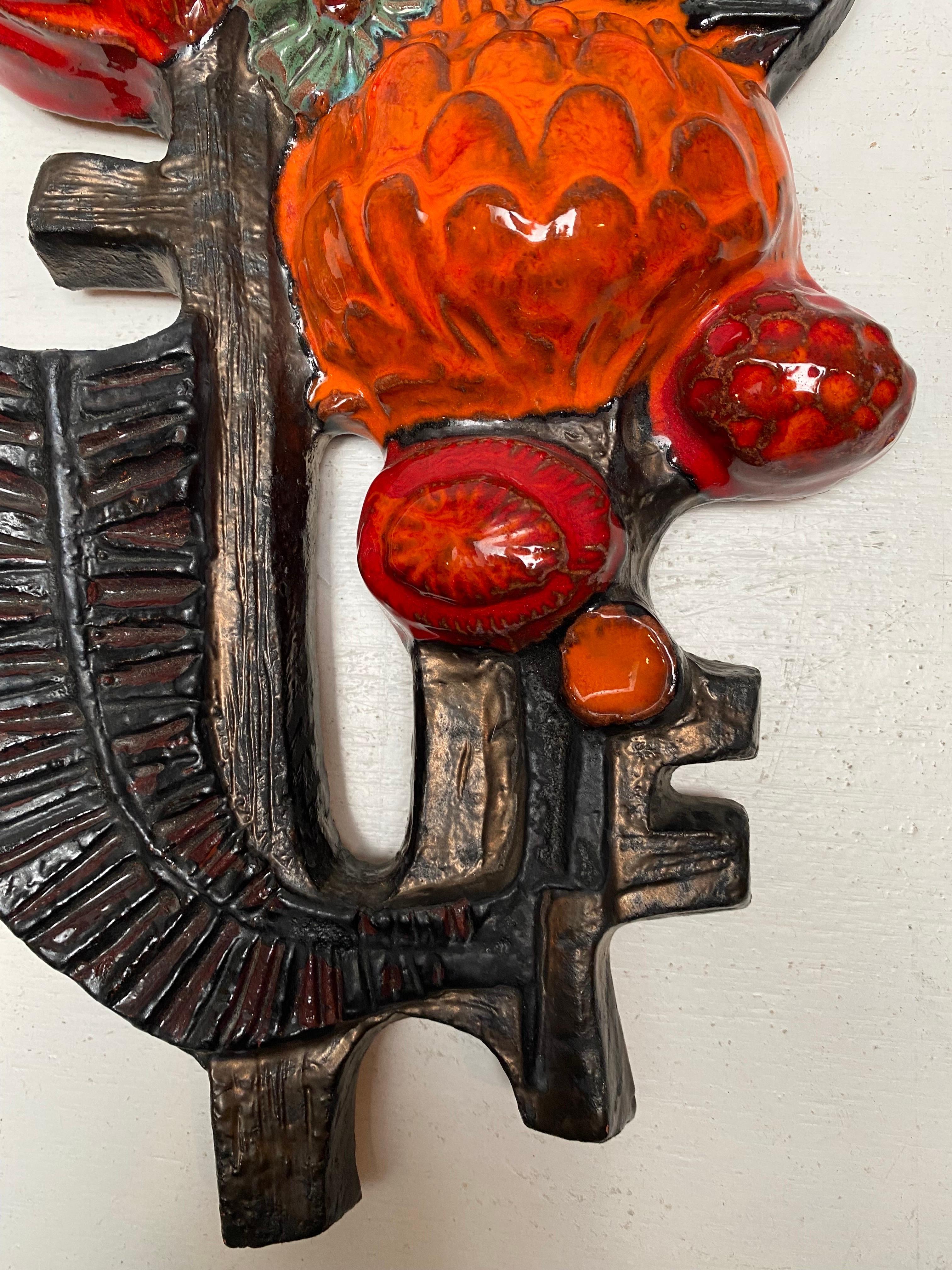 Beautiful abstracted flower wall sculpture was a cooperation between Perignem and Paul Vermeire.
a colorful decorative ceramic wall mounted sculpture with colors in deep red, black and orange glaze. The sculpture is in perfect condition. 