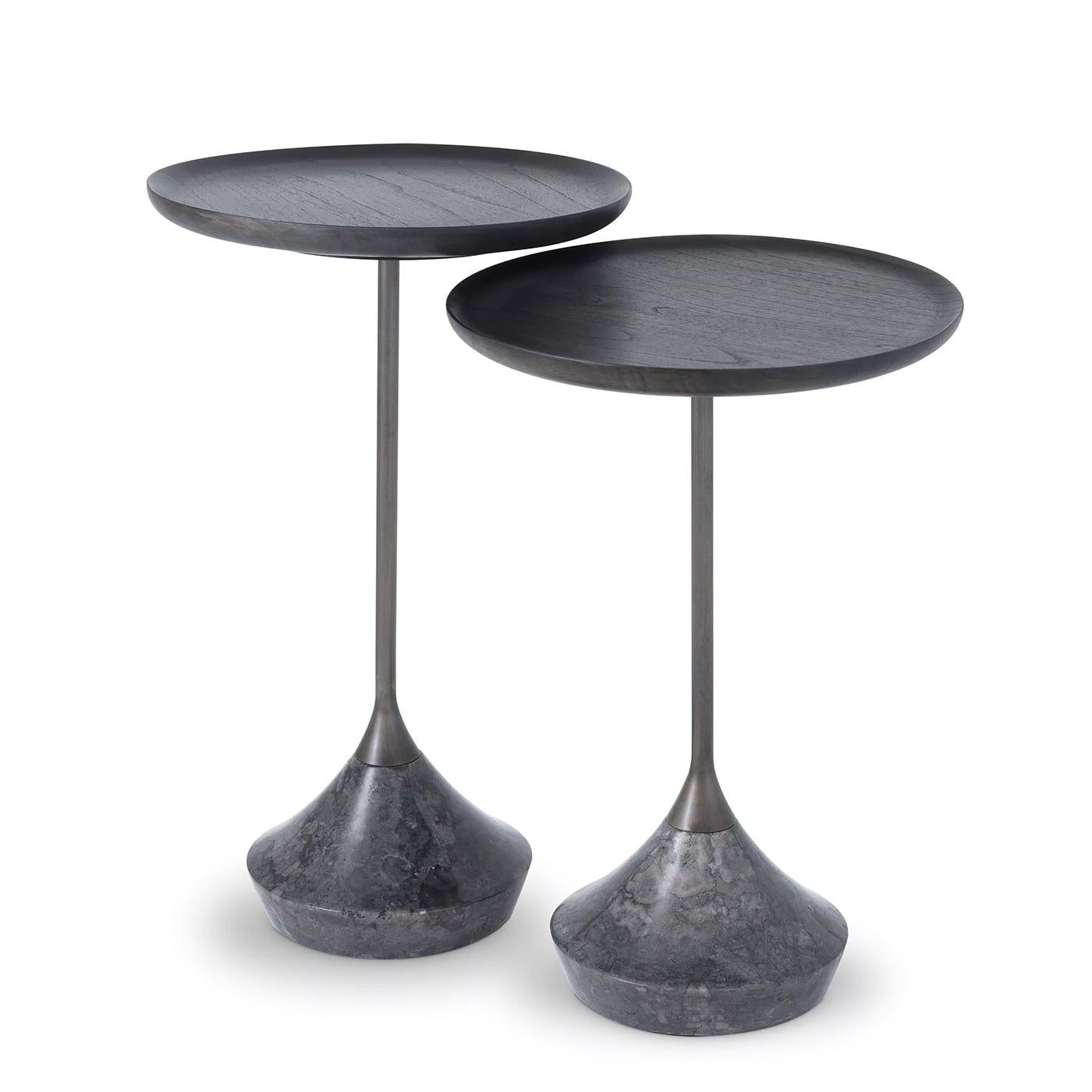 Side Table Perini Set of 2 with structures in stainless steel in bronzed finish,
with Mindi wood tops in blackened finish. Bases in polished dark grey marble.
Set of 2 side tables:
A/ Diameter 35cmxH56cm.
B/ Diameter 35cmxH50.5cm.
