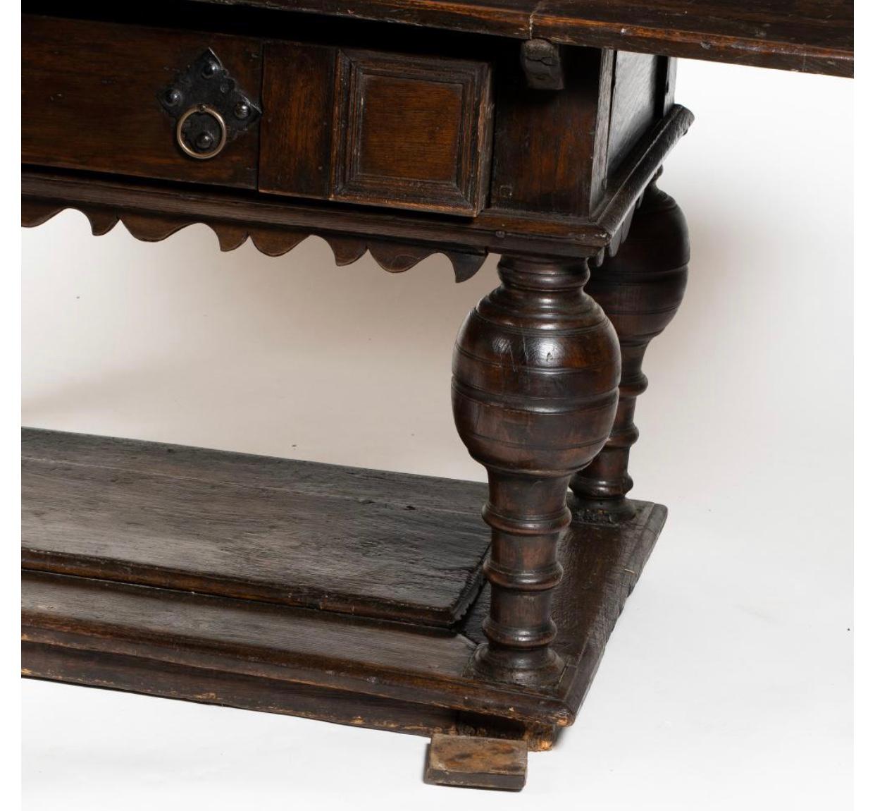 Period Oak Jacobean Library or dining table with baluster form legs, drawer and carved apron.  Good early piece with great patina yet has some restorations as expected.  Nice color.  And modern size.