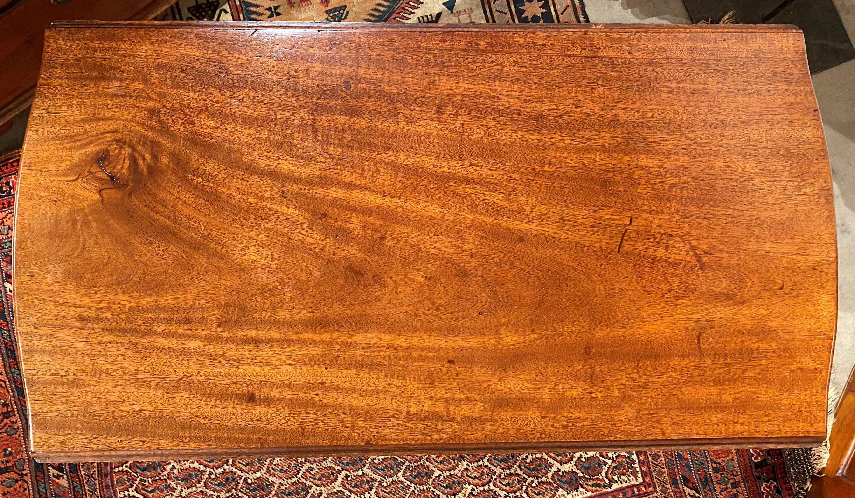 A fine example of an 18th century drop-leaf mahogany Pembroke table with shaped top, single drawer with original brass pull, accented with delicate inlay around the drawer, and supported by four tapered legs. Probably Portsmouth NH or North Shore