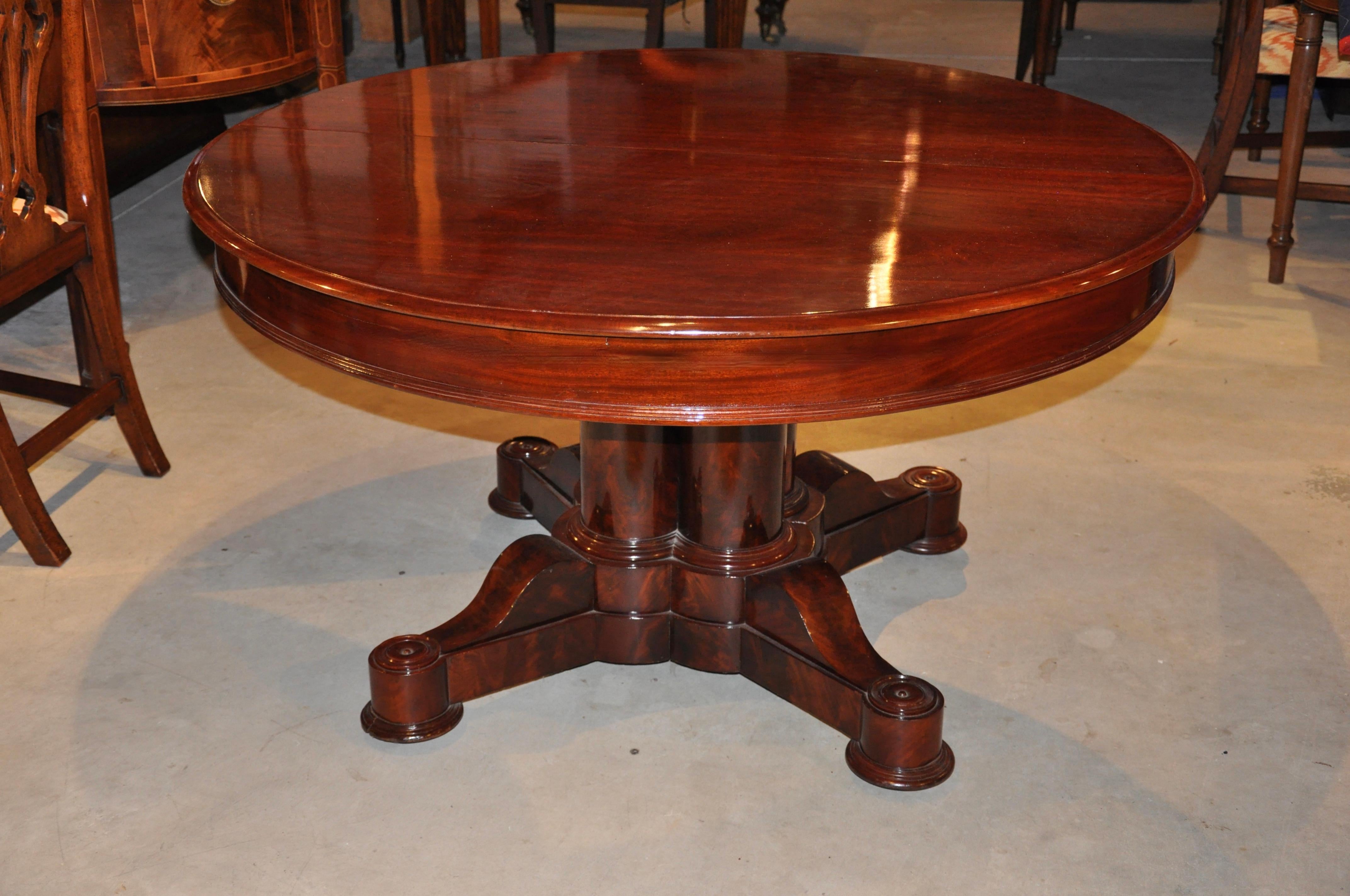 Period Boston Federal mahogany round dining table with four extension leaves (original)

Split pedestal base with four Round neoclassical column pedestal, Cuban and African Crotch Grain mahogany, attributed to Cornelius Briggs, Boston
Briggs