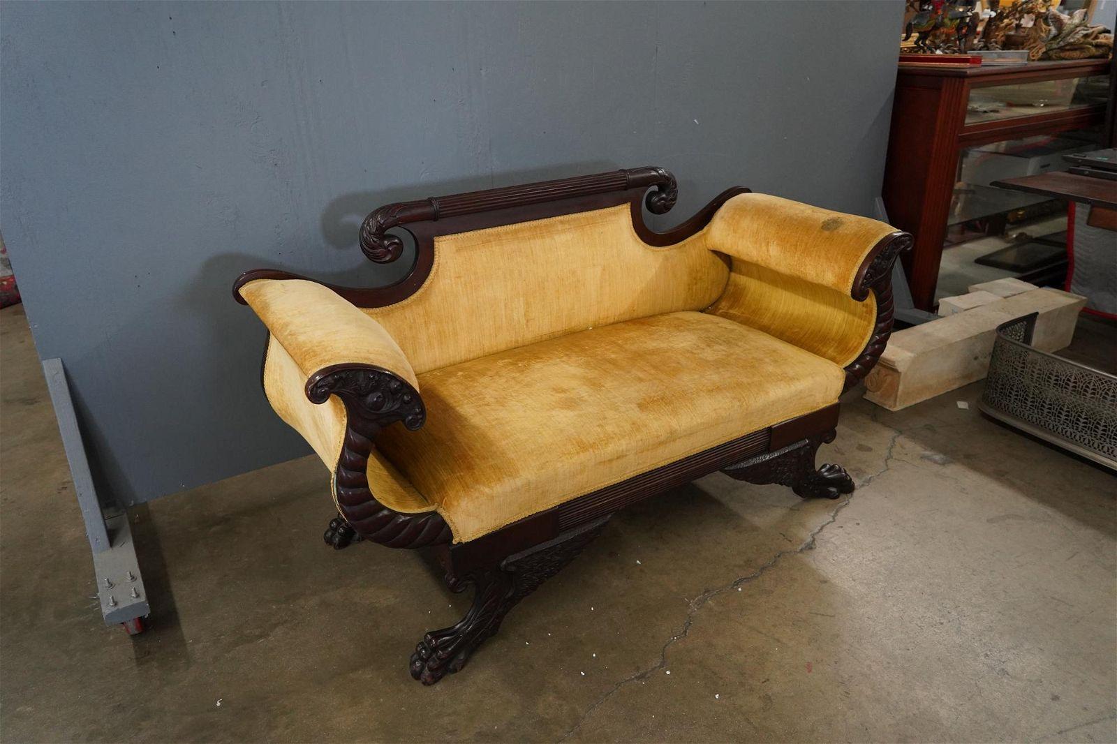 Circa 1800 American Federal highly carved mahogany sofa with scrolled carved headrest, curvelinear arms and outswept hairy paw feet upholstered in a vintage old striated velvet fabric