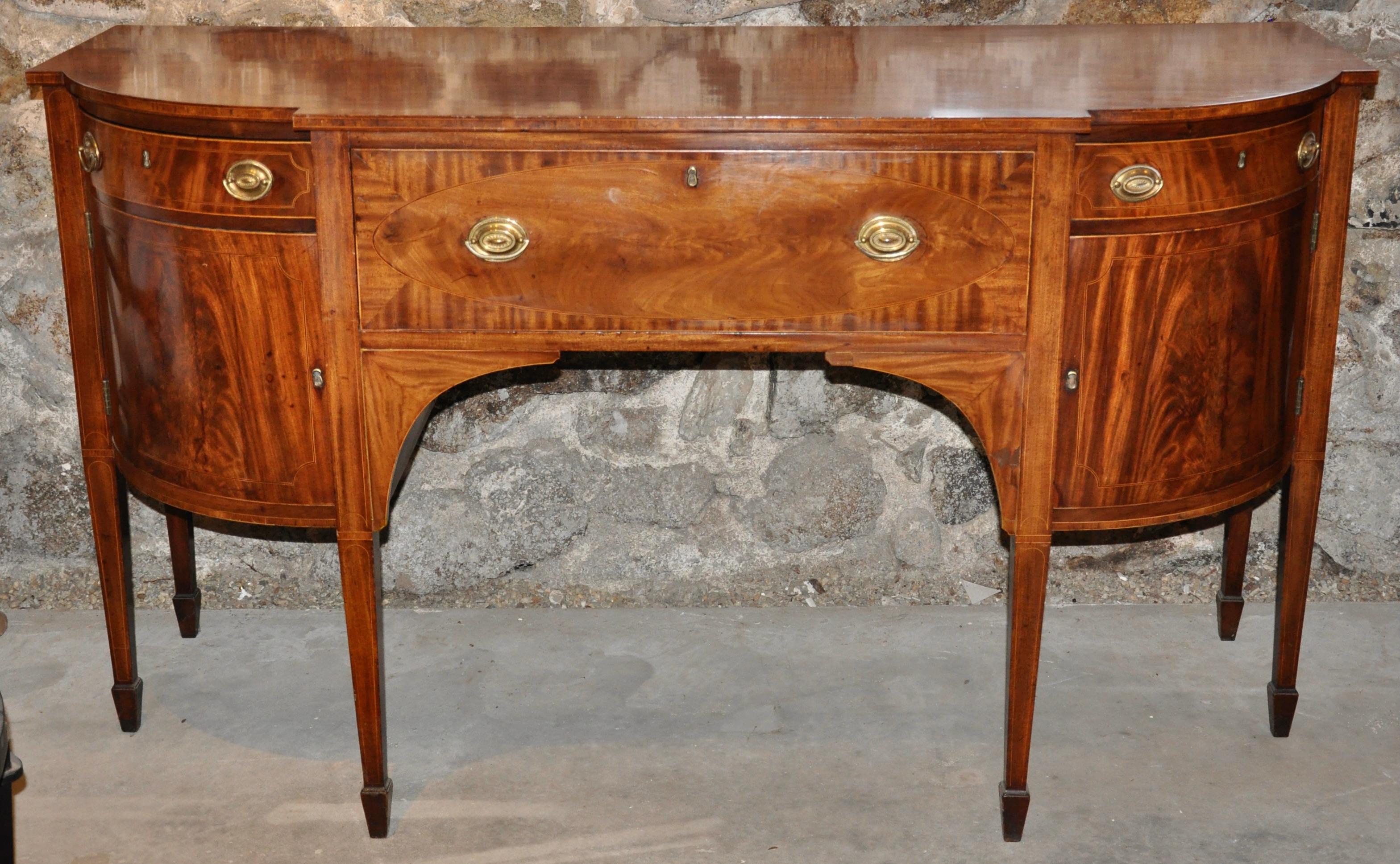 Period early 19th century American Federal mahogany sideboard

Tapered Hepplewhite legs with original spade feet
Two side cabinets, two side drawers, original compartmented desk interior
Beautiful mellow patina, minor restoration and well