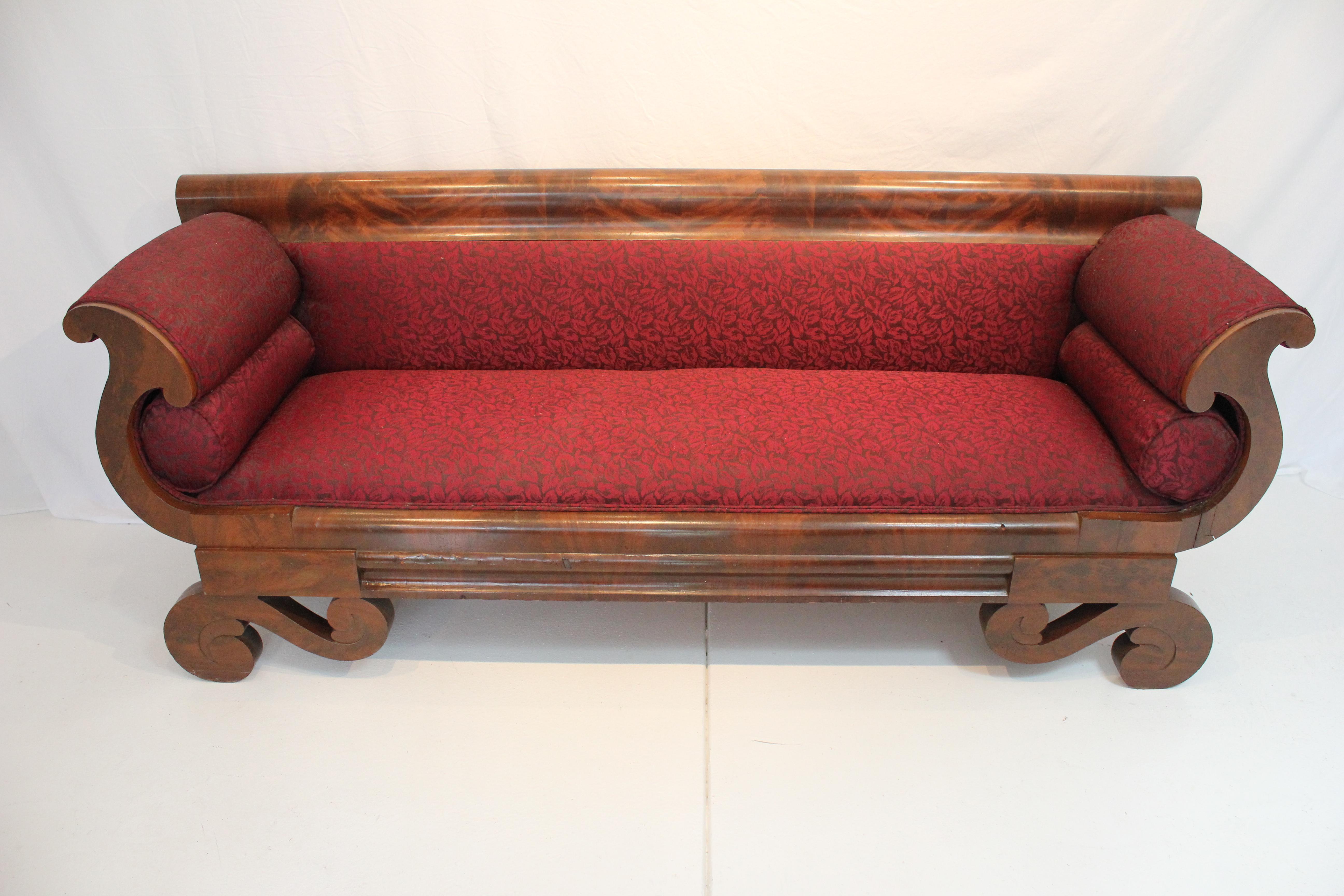 Period Antique American Empire Bench Sofa With Classical Empire Scrolled Arms and Feet. Flame Mahogany Wood Trim Over Solid Hardwood Construction and Hand Dovetailed Joinery. Eight way hand tied seat foundation.  A very solid, quality hand made