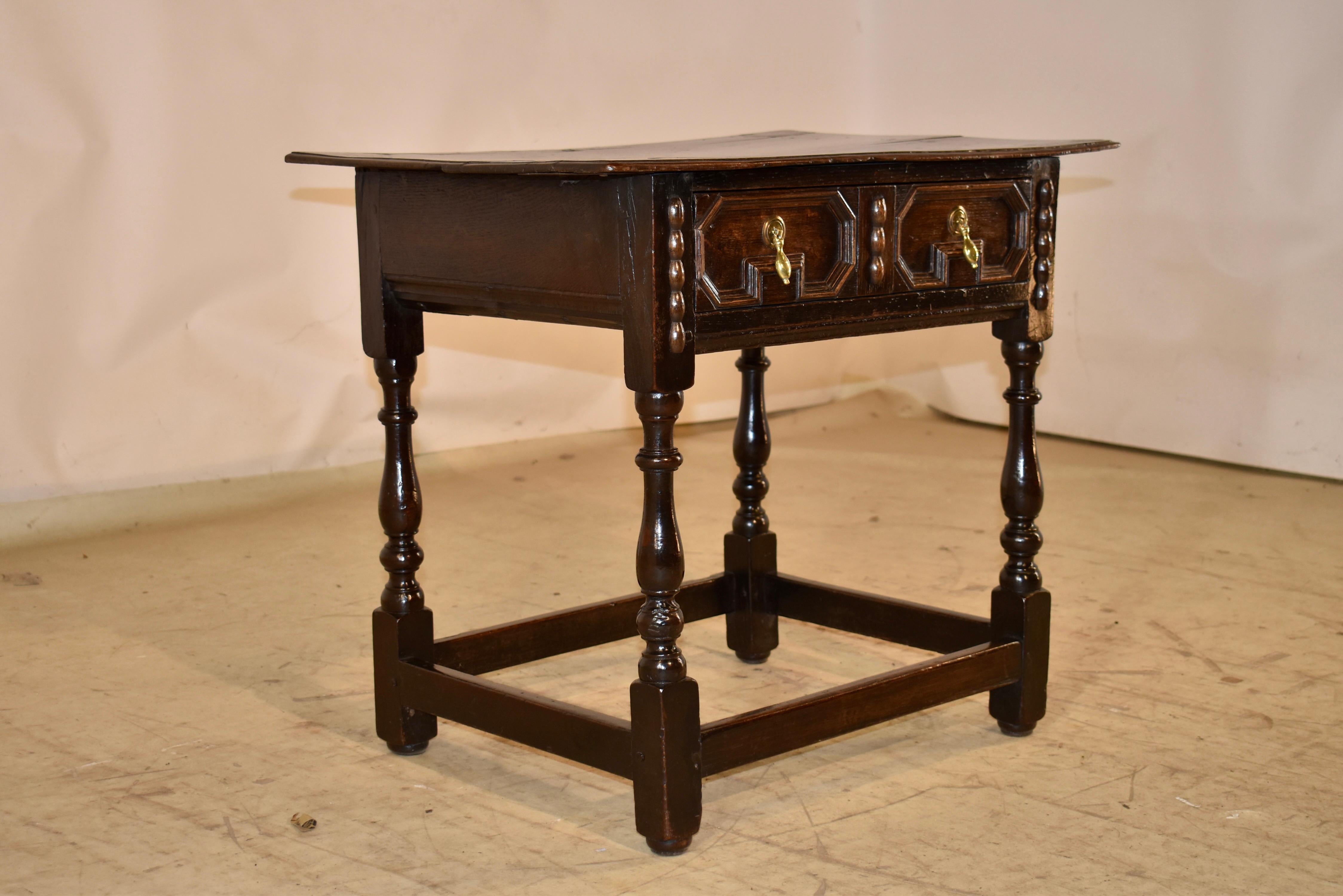 Period Charles II oak side table from England.

This is an absolutely stunning side table.  It has a two plank top, which has a beveled edge and pegged construction.  The top has shrinkage, which is appropriate for a table of this age.

The top
