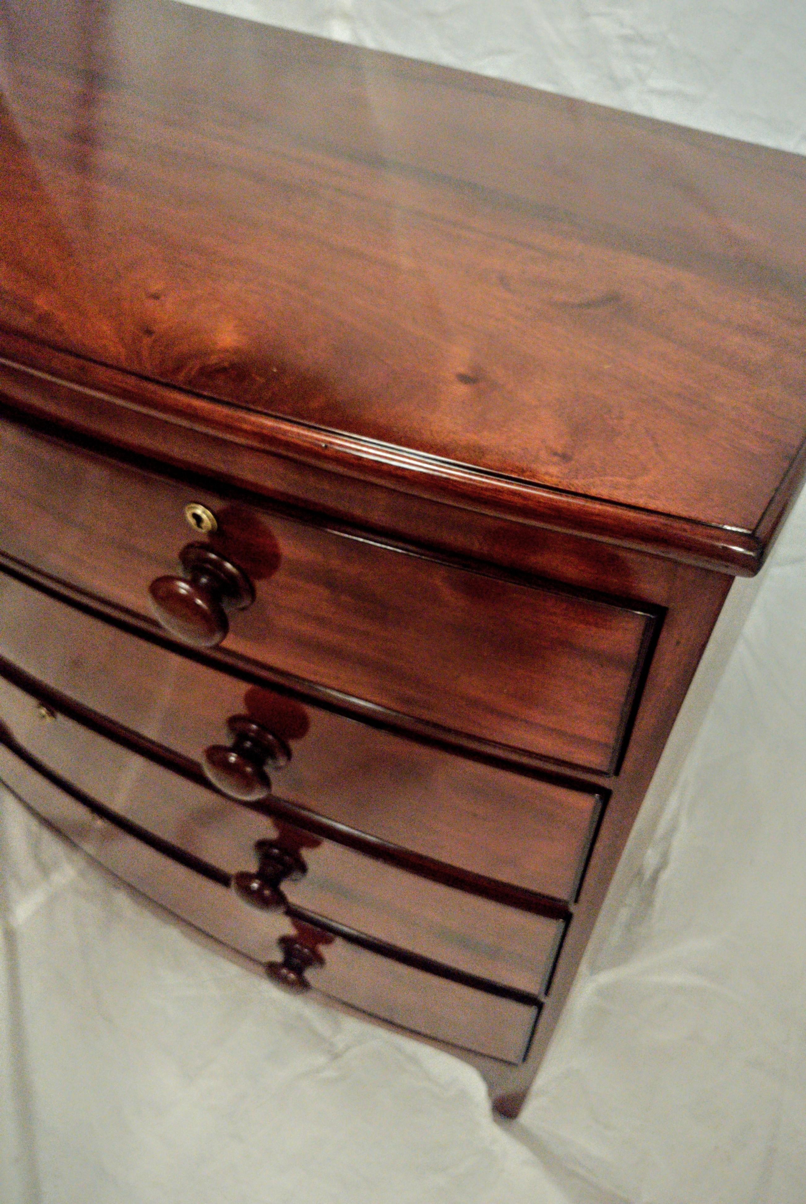 Early 19th Century Georgian/English Five Drawer Chest in mahogany. This high country chest is a wonderful example of elegant simplicity in it crisp lines and refined style. With five cock-beaded drawers and wonderful figured drawer fronts. The