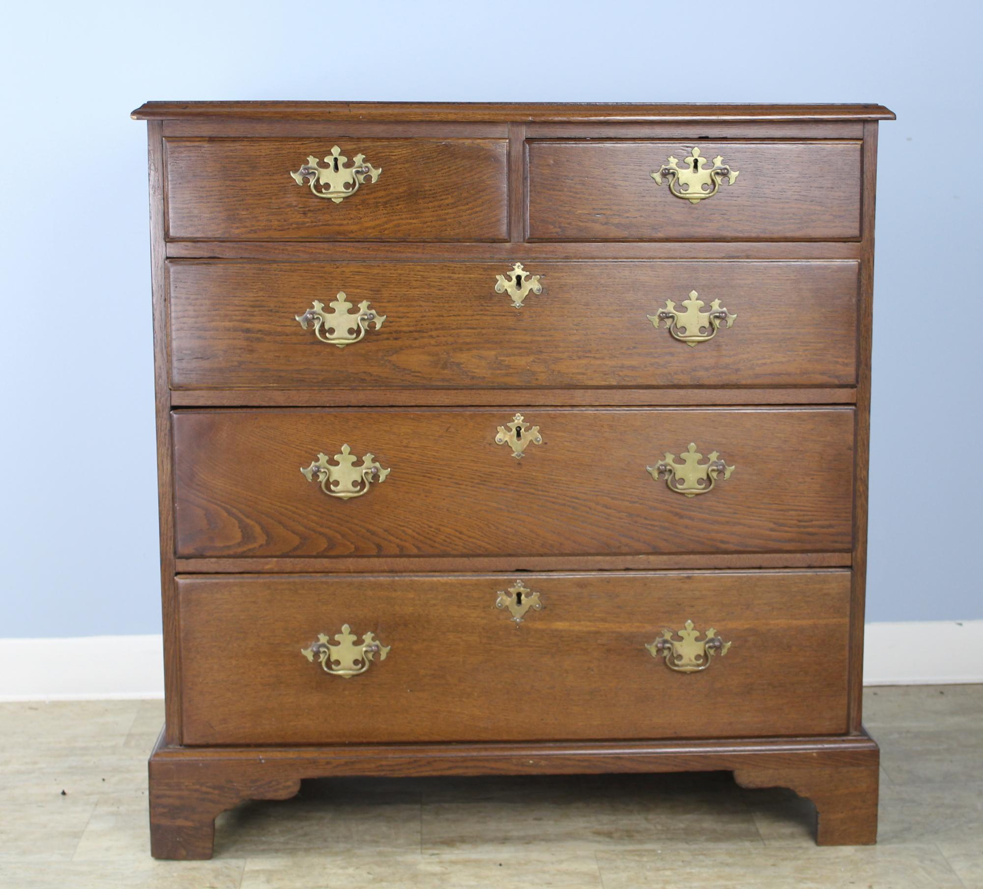 Beautiful original brasses are a highlight of this terrific early oak dresser. Two drawers over three make this a Classic and very attractive configuration. The smooth patinated top and the gentle ogee edge enhance the overall look. The bureau's