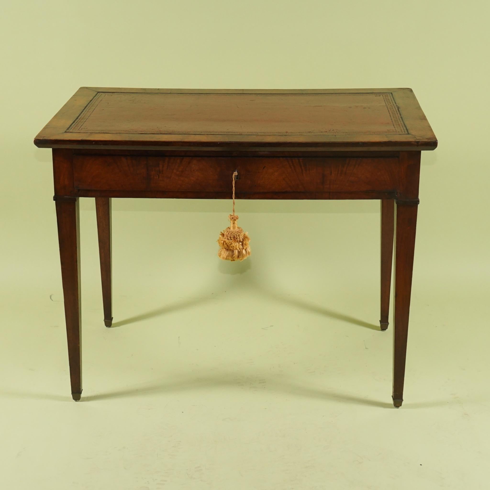 This beautiful period writing table was constructed in France circa 1790 to 1800 of rich imported mahogany and the woods have been carefully selected to create an overall pattern of flaming grain around the apron of the table. The top is covered in