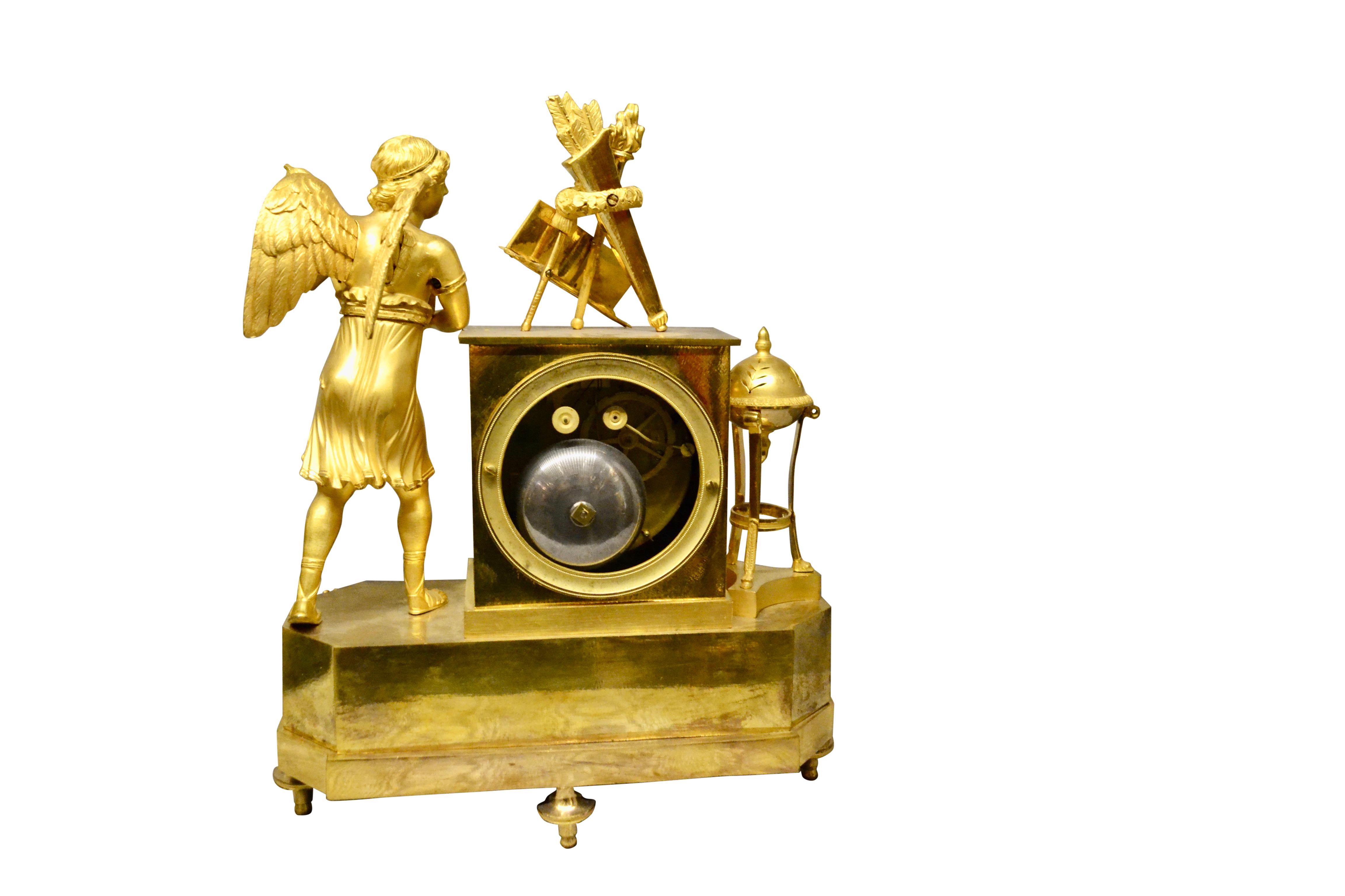 Bronze Period French Empire Mantle Clock Depicting a Winged Cupid Playing a Lute For Sale