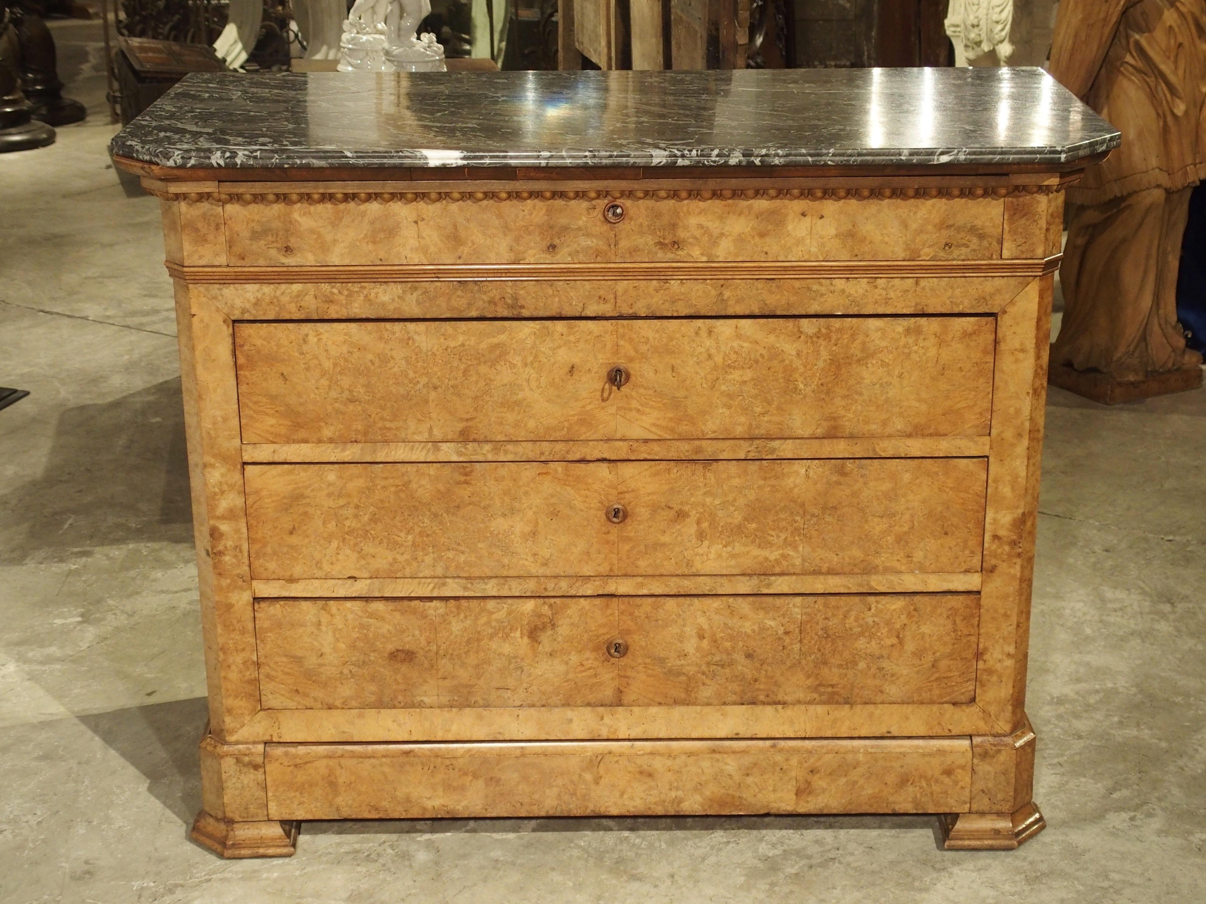 This bright and clean-lined chest of drawers is known as a Louis Philippe commode. It is an authentic piece, dating to the reign of Louis Philippe, around 1840. It has been constructed of a beautiful, light blonde burled walnut wood veneer, and it