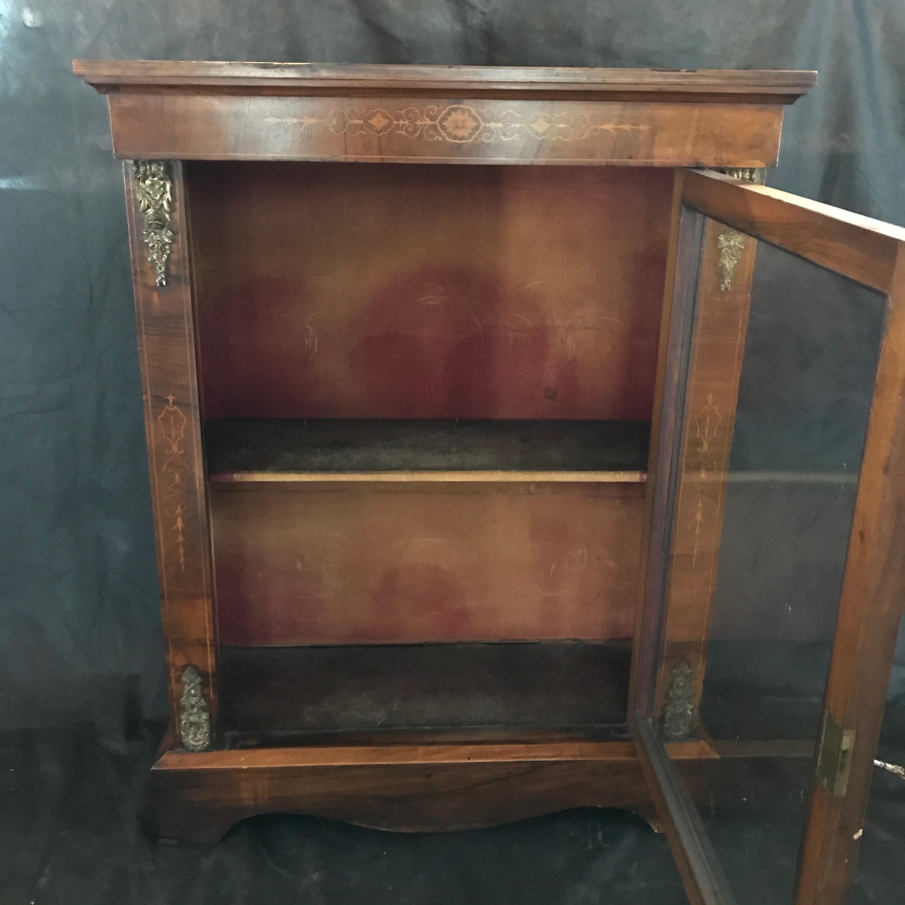 French walnut bookcase or display cabinet with beautiful marquetry and gold detail. Original interior! 
 
 #4578.
