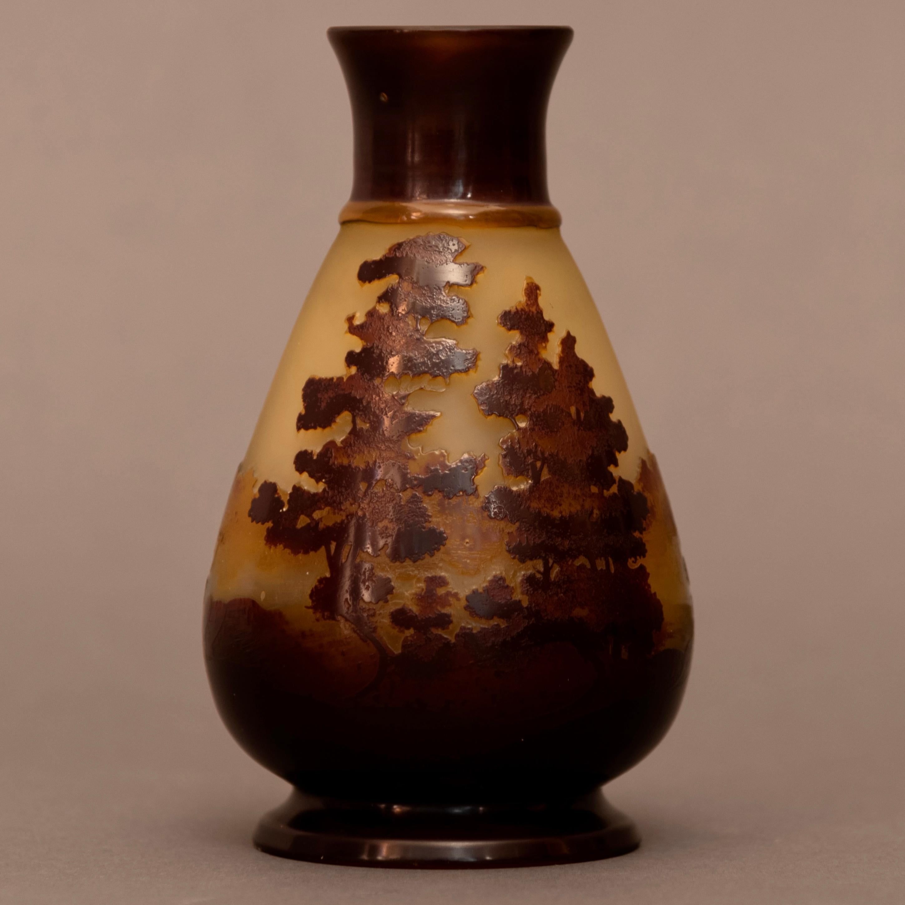 This vase shows a landscape of the Vosges region, a mountainous area in eastern France near Nancy. Known for the striking blue colour of the mountains at dawn. This was the homeland of Emile Gallé.