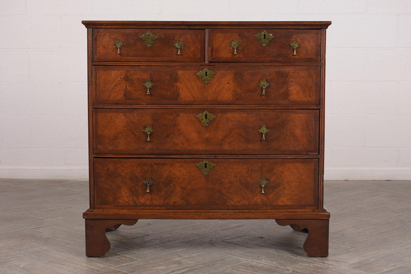 This period George III Mahogany chest feature a wooden top, five drawers, and original locks. It has two small top drawers, three large pull drawers, and each has original brass drop handles and large key plates. All the drawers open and close with