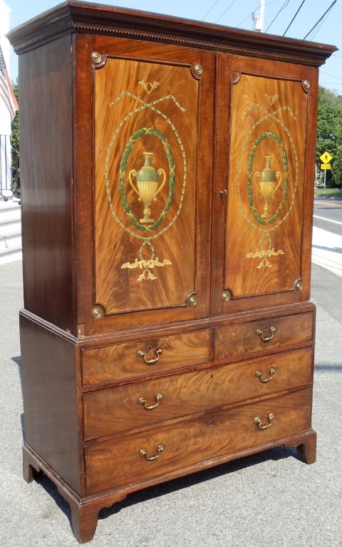 Period figured African crotch grain mahogany linen press. George III. Dentil Molding, Paneled Doors, Exquisite Wood Selection. Now with well executed neoclassical traceries and interior.