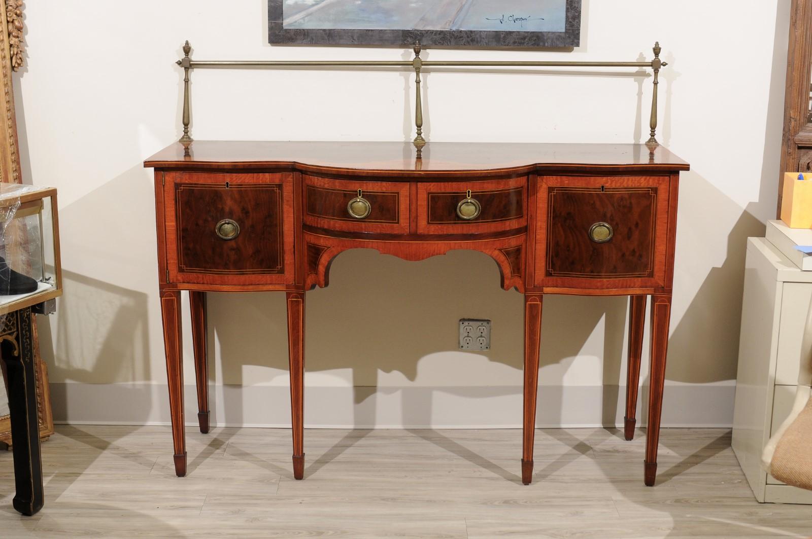 This magnificent sideboard is exceptional ! The size is perfect for large or small room
The piece has the original 13 inch brass back rail and beautiful marquetry inlay on the top. Notice the picture with the urn on top center. Lovely!!
The front