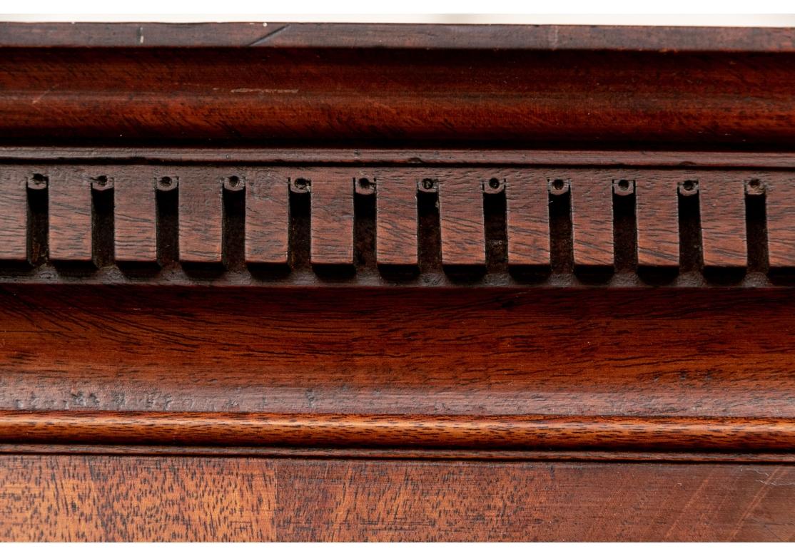 The Chest On Chest with classic elegant Georgian lines. The upper chest with a carved cornice with a dentil frieze. A burled band is over the two short over three long graduated drawers. The lower chest with three long graduated drawers. All drawers