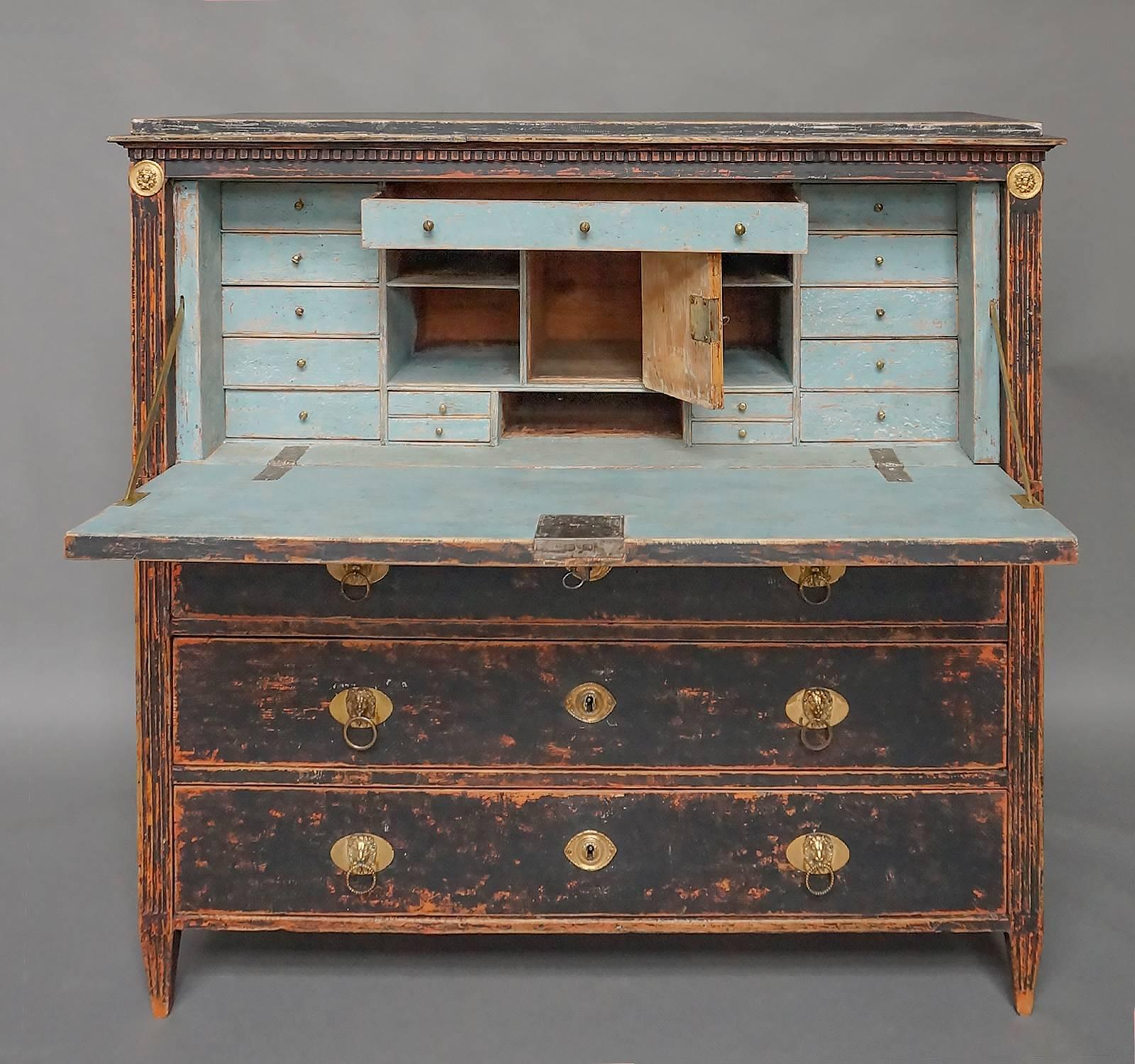 Swedish fall-front secretaire from the Gustavian period, circa 1800. Constructed in two parts, the upper section is fitted with fifteen drawers, several open compartments, and one storage area with reeded door. There are brass medallions with