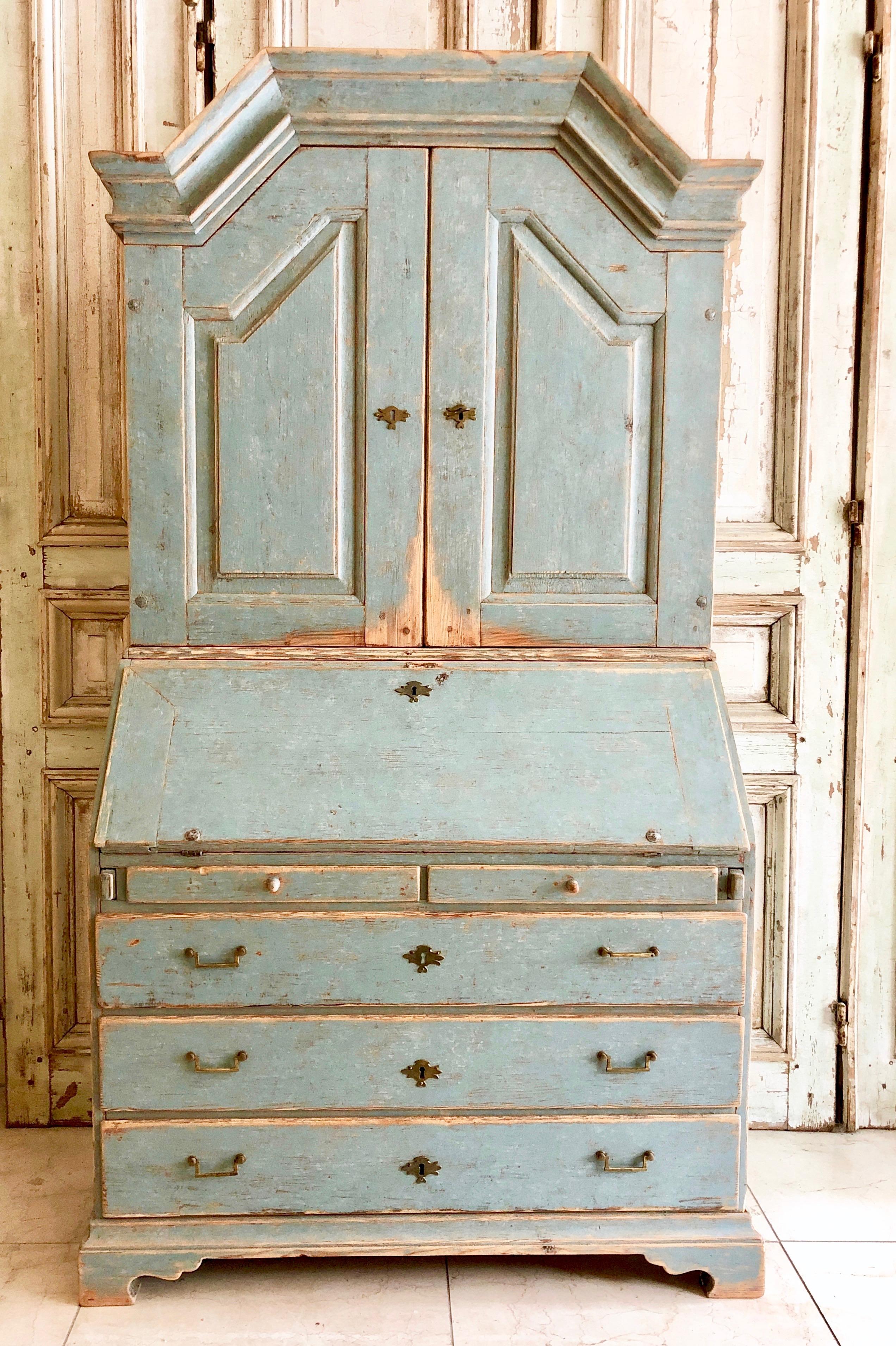 A very fine example of early 19th century secretaire cabinet of Gustavian period with a high arching pediment cornice and panelled doors with date indicading that this cabinet was given later as a wedding gift 1840. The fall front desk with