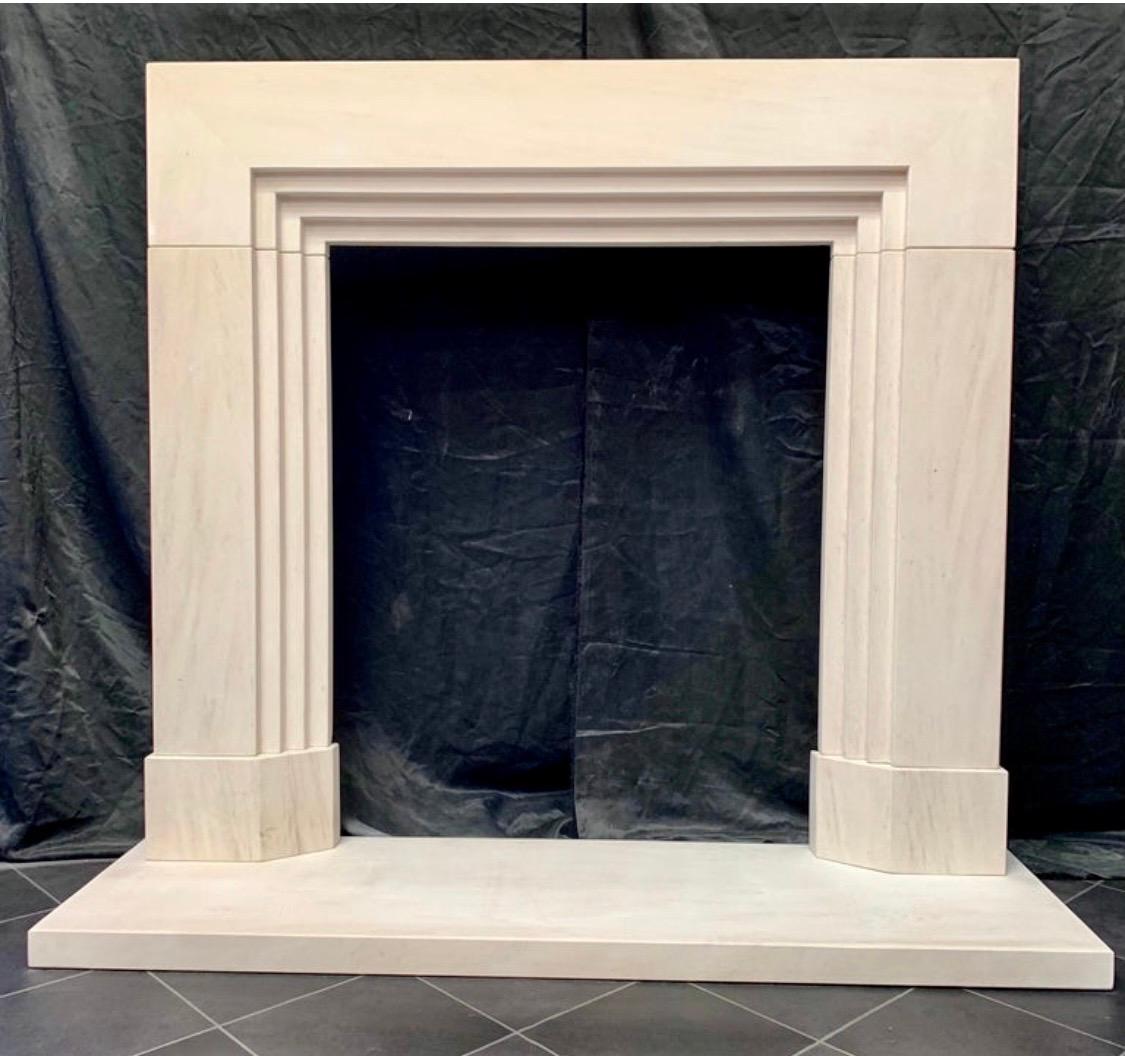 A charming and fully restored Period Limestone Art Deco fireplace surround of great quality, available with its original hearth plate, attractive stepped sections form the basis of this piece, all carved from a solid section, finishing on to splayed