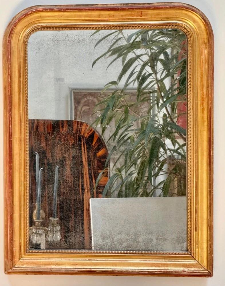 Unknown Period Louis-Phillipe arched, gilded mirror