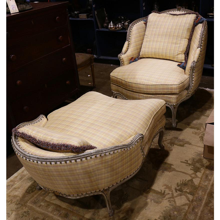 Mid 18th Century French Louis XV two piece bergere chaise, having a partial gilt and paint decorated frame surrounding the upholstered seat and back, with loose cushions, and rising on cabriole legs.