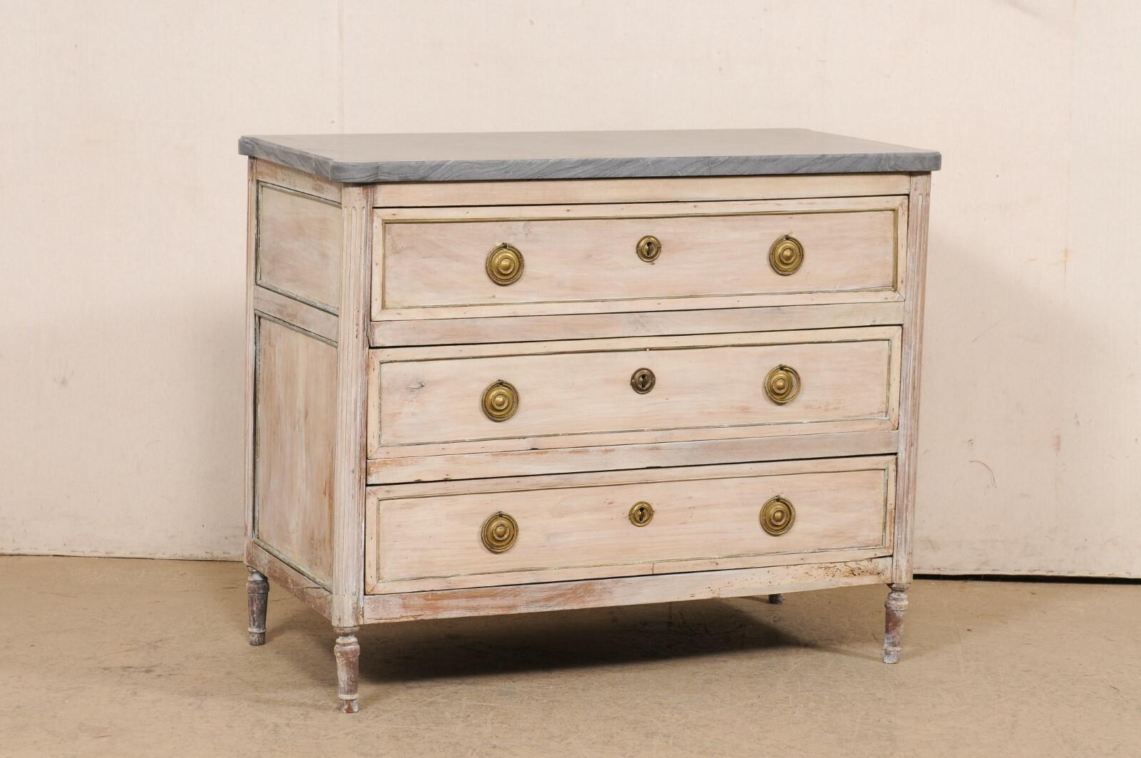 A French Neoclassical period carved wood commode, with stunning new custom marble top, from the early 19th century. This antique chest from France features rectangular-shaped marble top, with pronounced and outwardly rounded corners, which rests