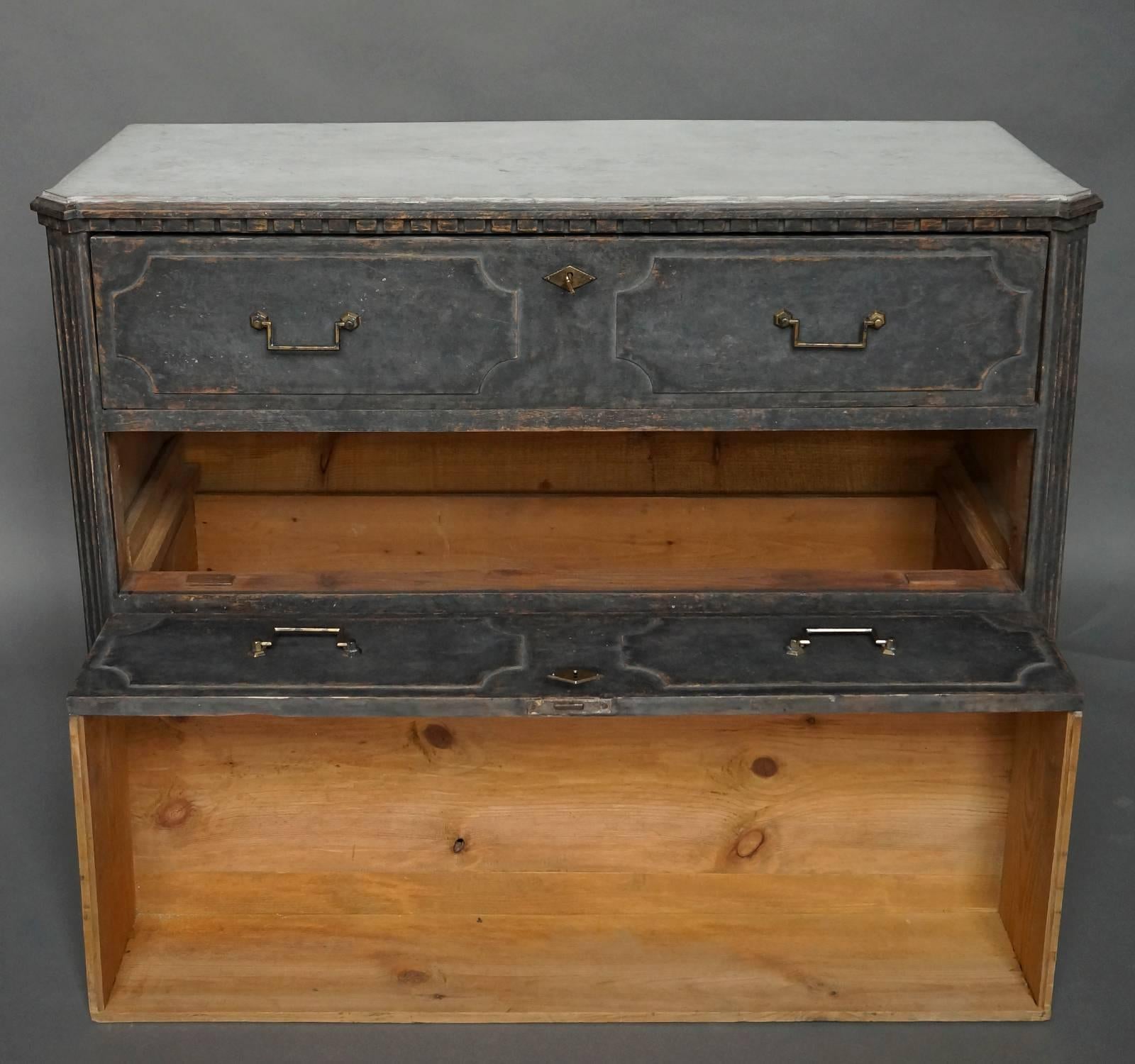 Swedish neoclassical chest of drawers, circa 1820. Each of the three drawers has a pair of raised panels, brass pulls, and a brass escutcheon. Worn black paint with a white top.