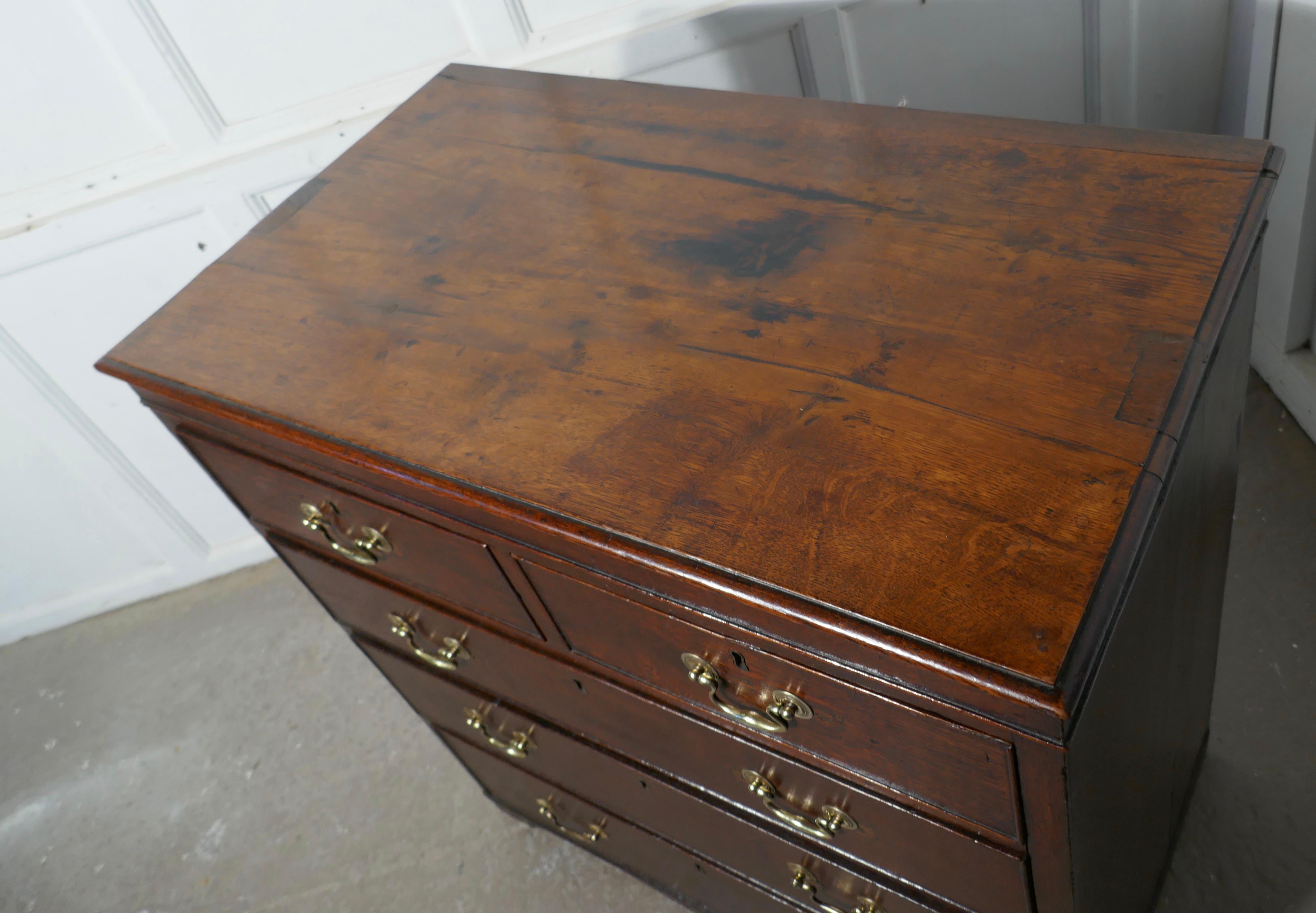 This charming old oak Georgian chest of drawers started life as a book press sadly the press which would have been on the top of the chest has long gone
The chest has two short drawers at the top and three longer graduated drawers beneath and it