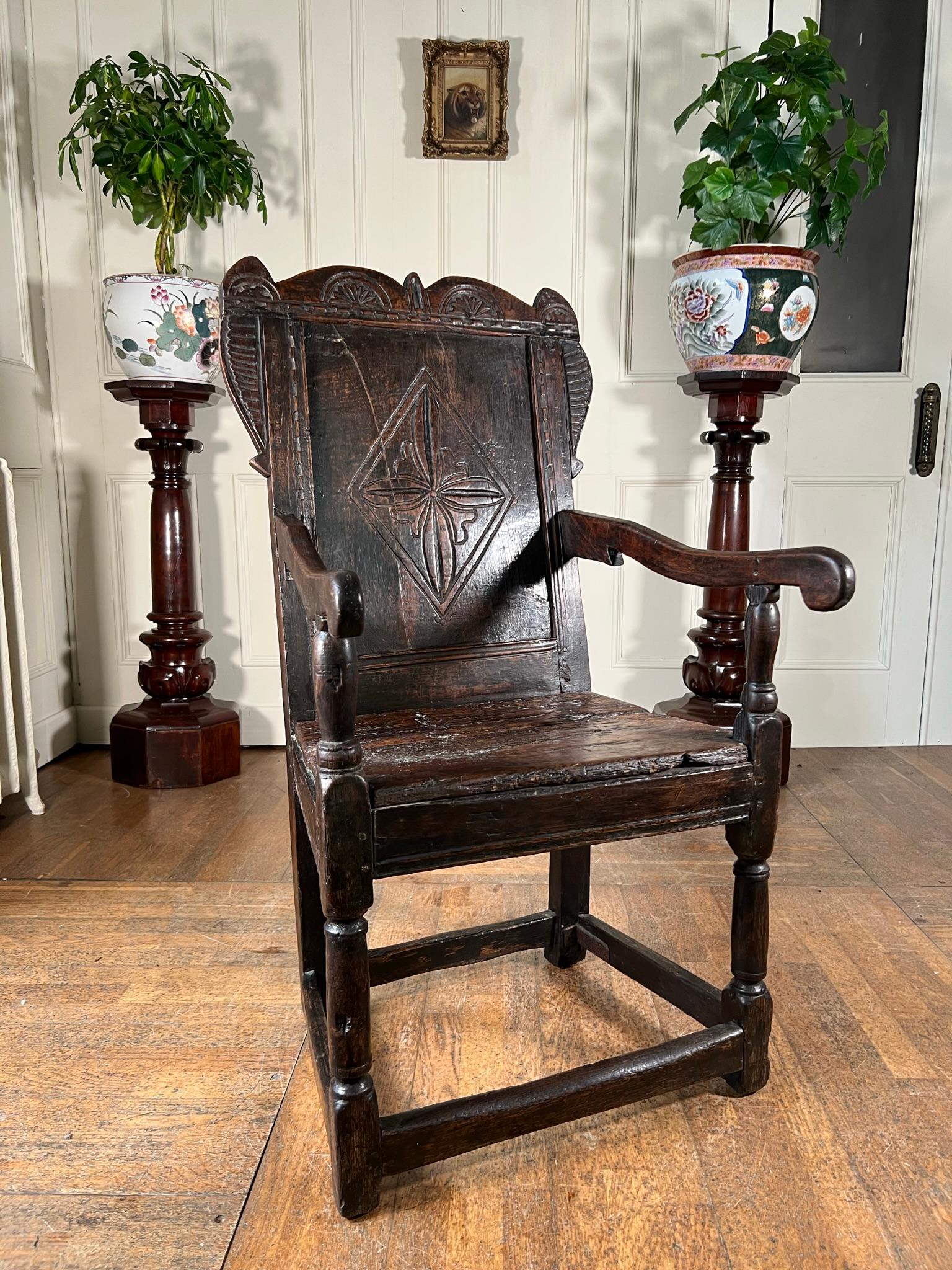 Early 18th century jointed armchair of large proportions.

Belonging to the head of the household this chair has been well used during its lifetime creating a beautiful patination to the oak, with signs of wear commensurate to age.

Single panel