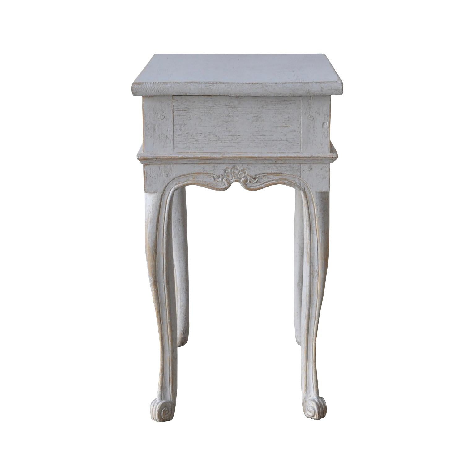 A period Rococo table with cabriolet legs, a single drawer, and a decorative carved stretcher. This piece has been repainted.
