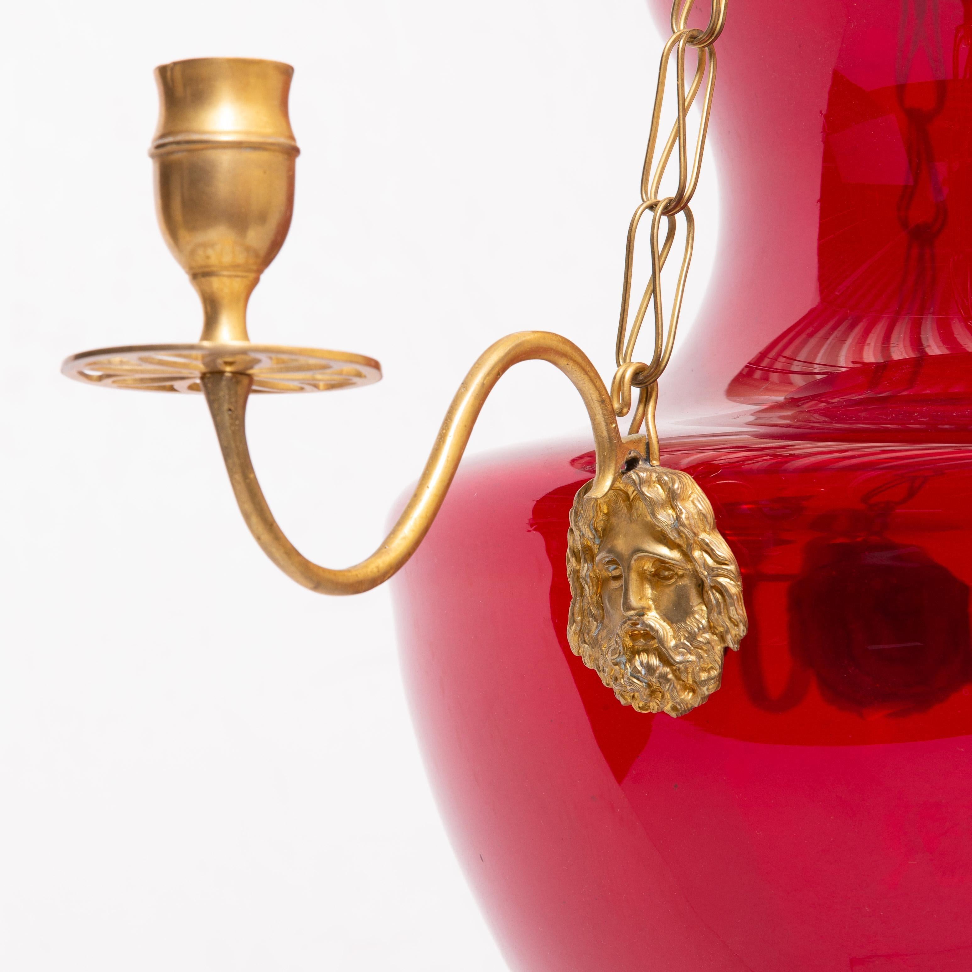 Early 19th century Swedish or Russian ruby glass chandelier or lantern

-- Amphora shape with three neoclassical Bacchus masks and candle arms
with acorn and laurel leaf finials in Ormolu.