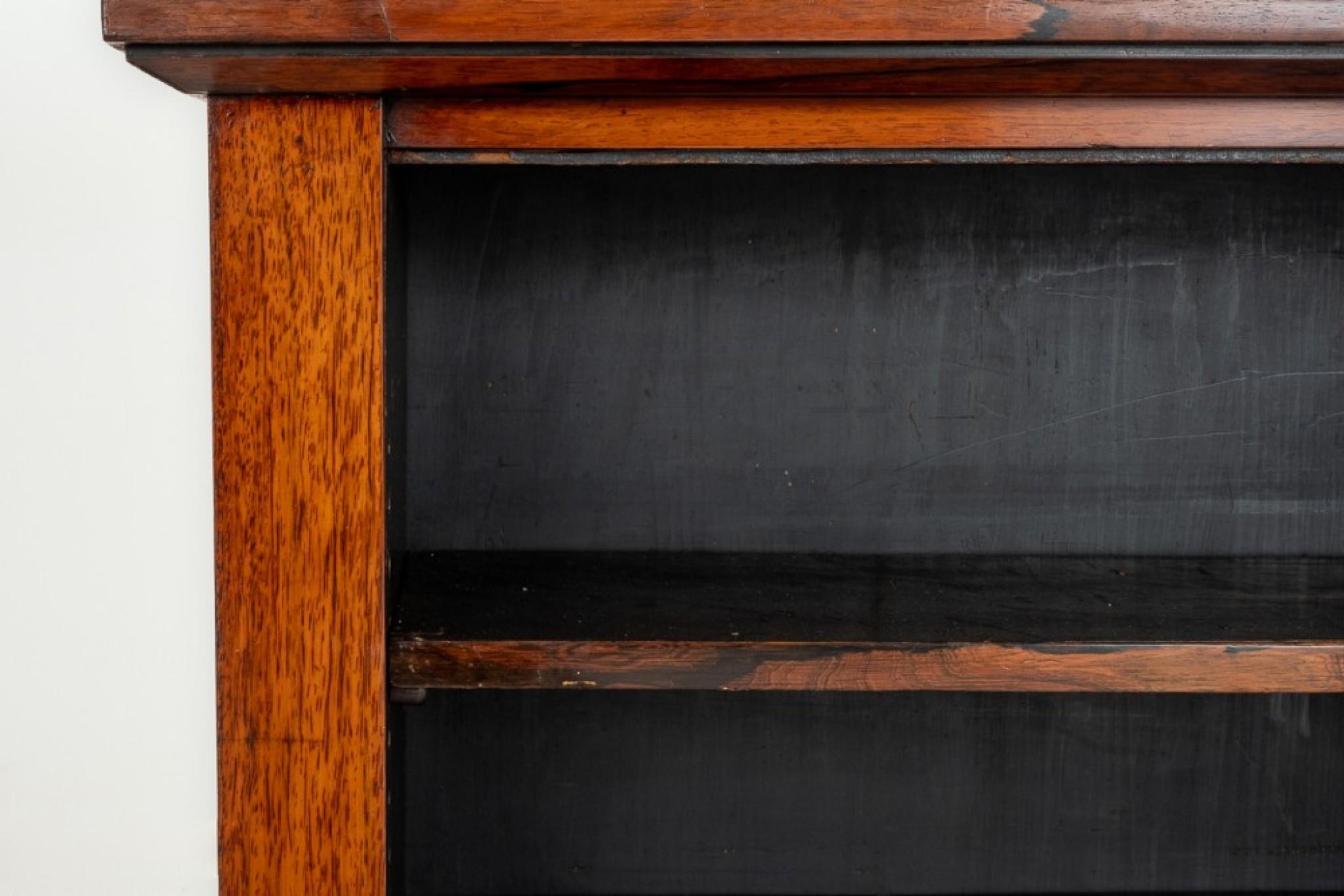 Unusual early Victorian open bookcase.
Circa 1860
This bookcase is raised upon a plinth base.
Having 2 adjustable shelves.
The top section is supported on turned columns with a small upstand and a mirrored back.