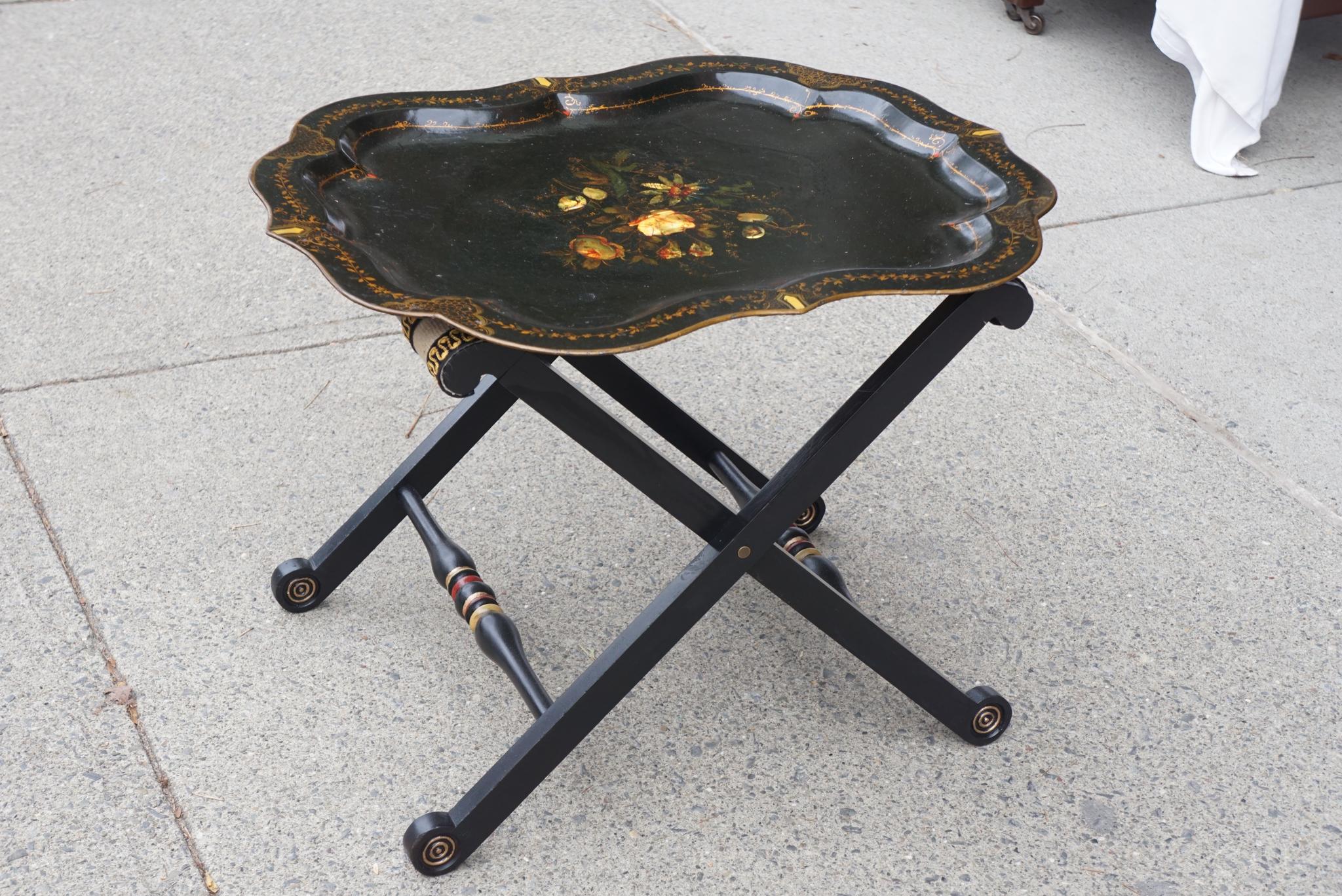 This lovely old tray made circa 1860 is inlaid with mother of pearl and tole decorated with flowers set into a lustrous lacquer surface applied to the tinware tray. The flowers are painted in a lively and realistic manner and the tray is further