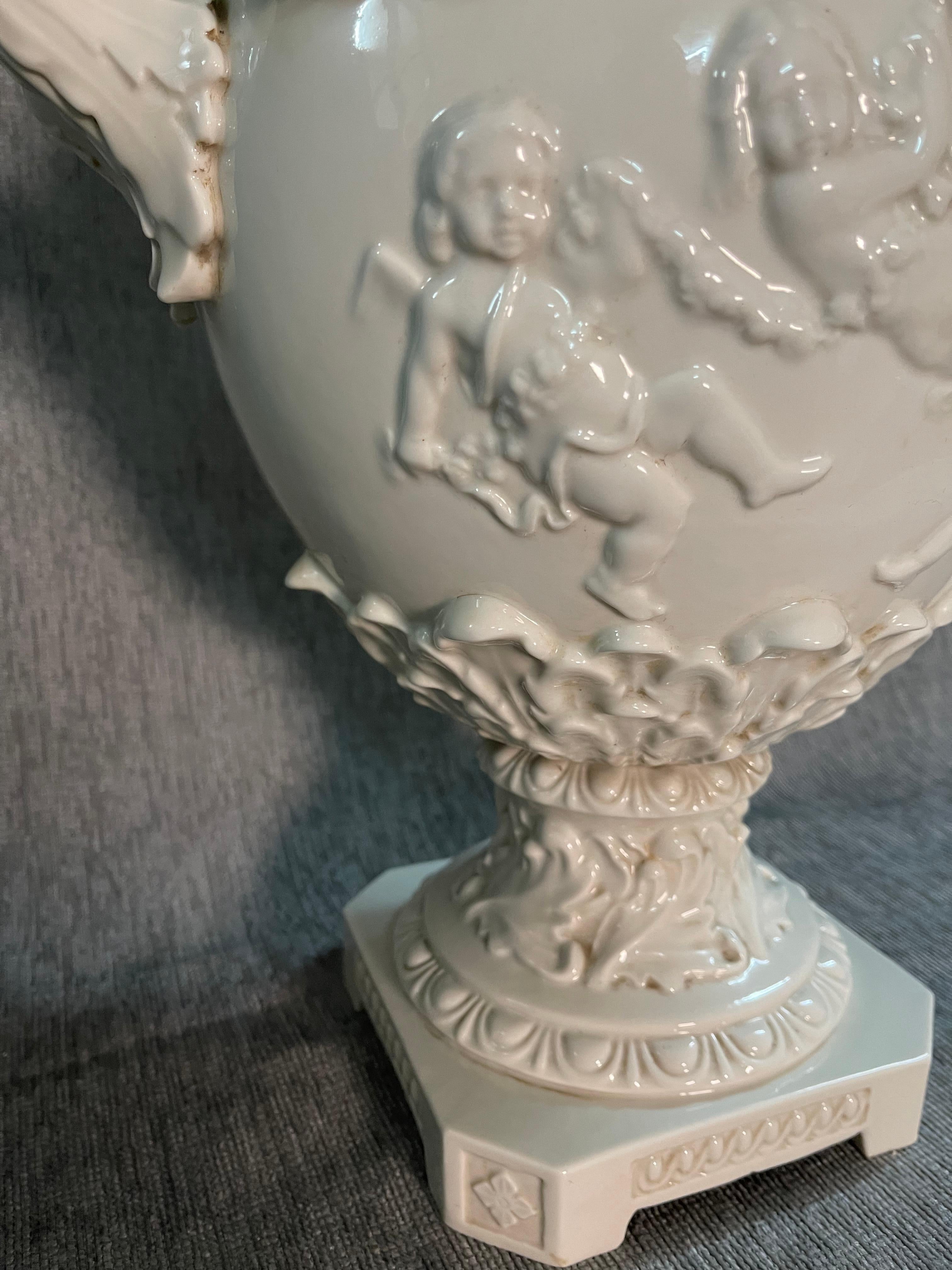 Large wonderful white glazed ceramic Capodimonte classical urn with lids on a tapering square base. 
Classic product of this famous Italian Maison Capodimonte 
This vase have elegants scrolled handles and is decorated on the bodies with importants
