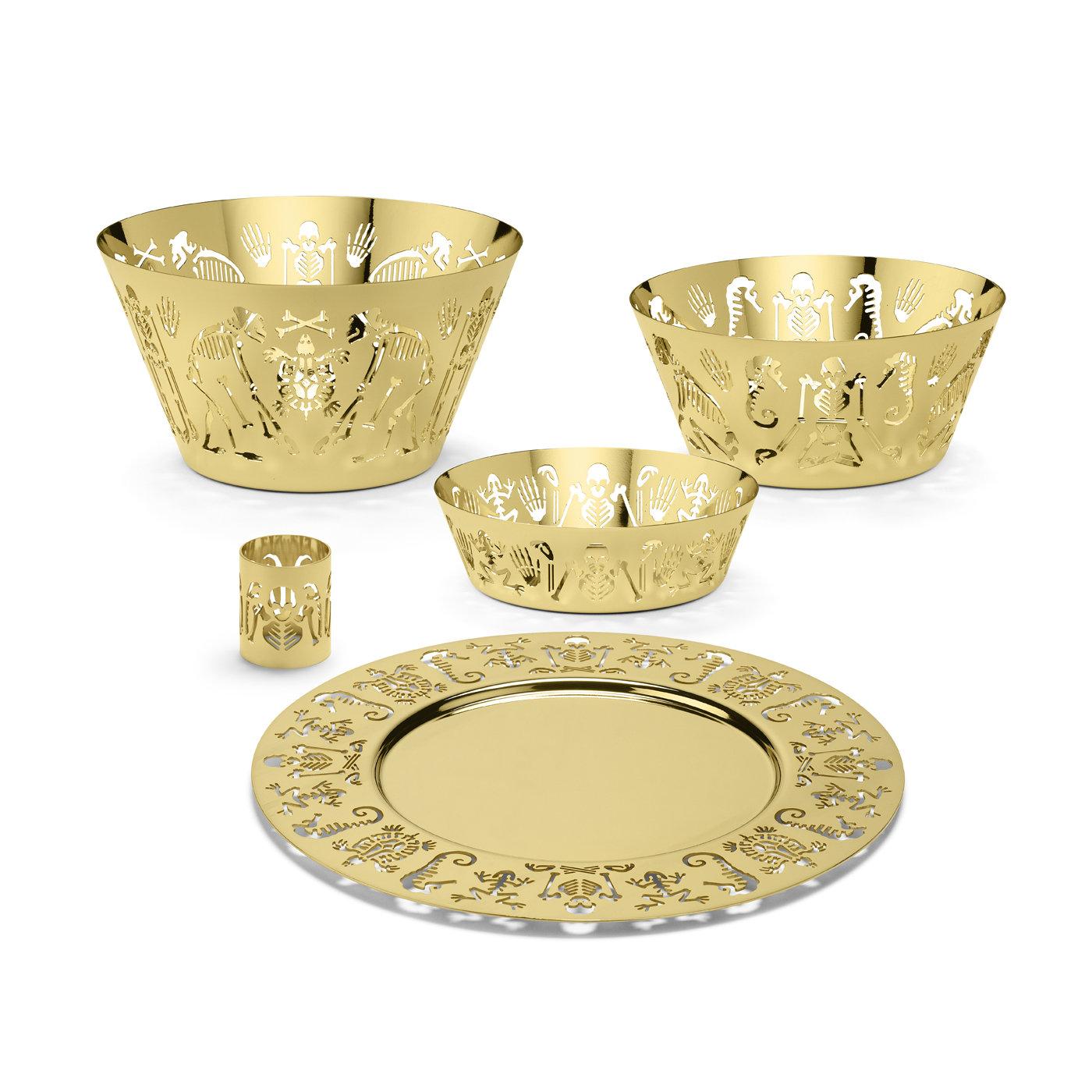 This large bowl is a superb object of functional decor that will elegantly serve food at a modern table while adding a unique and mesmerizing decorative accent. Entirely made of brass, the bowl's conical shape boasts a cut-out garland of human, ape,
