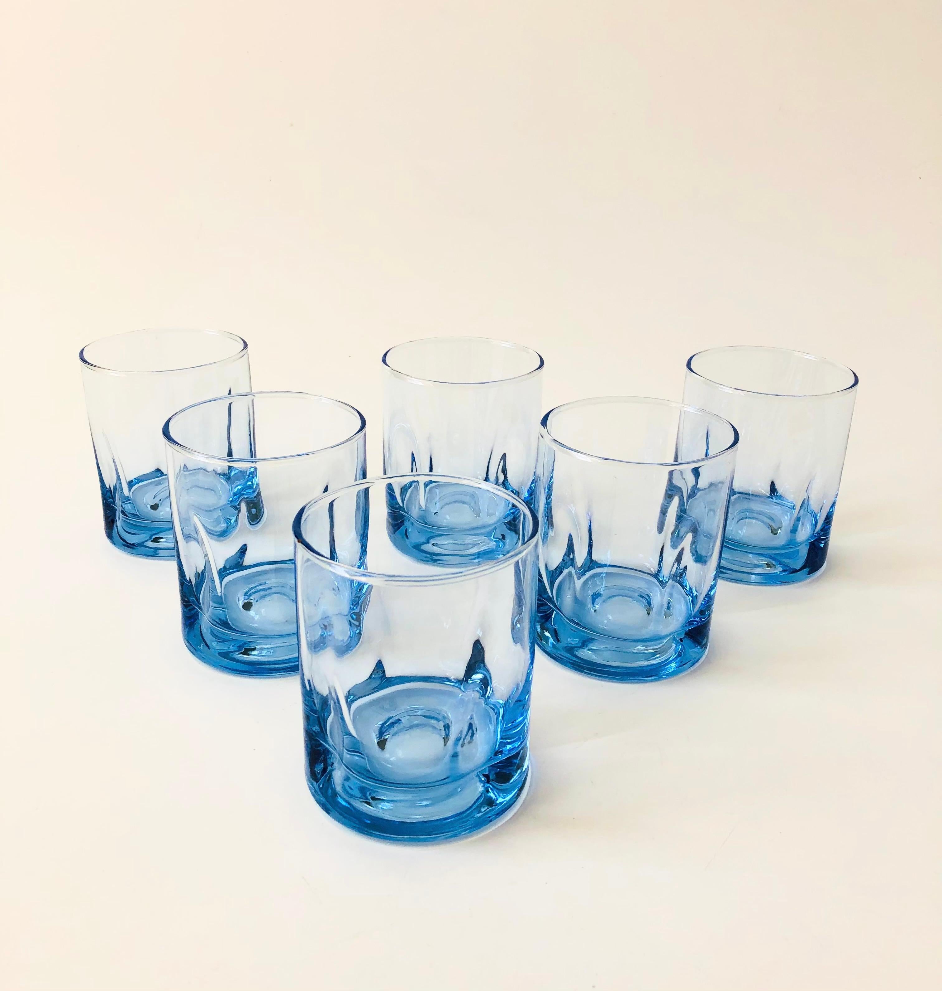 A set of 6 beautiful vintage cocktail glasses in a pale blue-periwinkel color. Each made out of thick glass with a great amorphous shape to the base.


