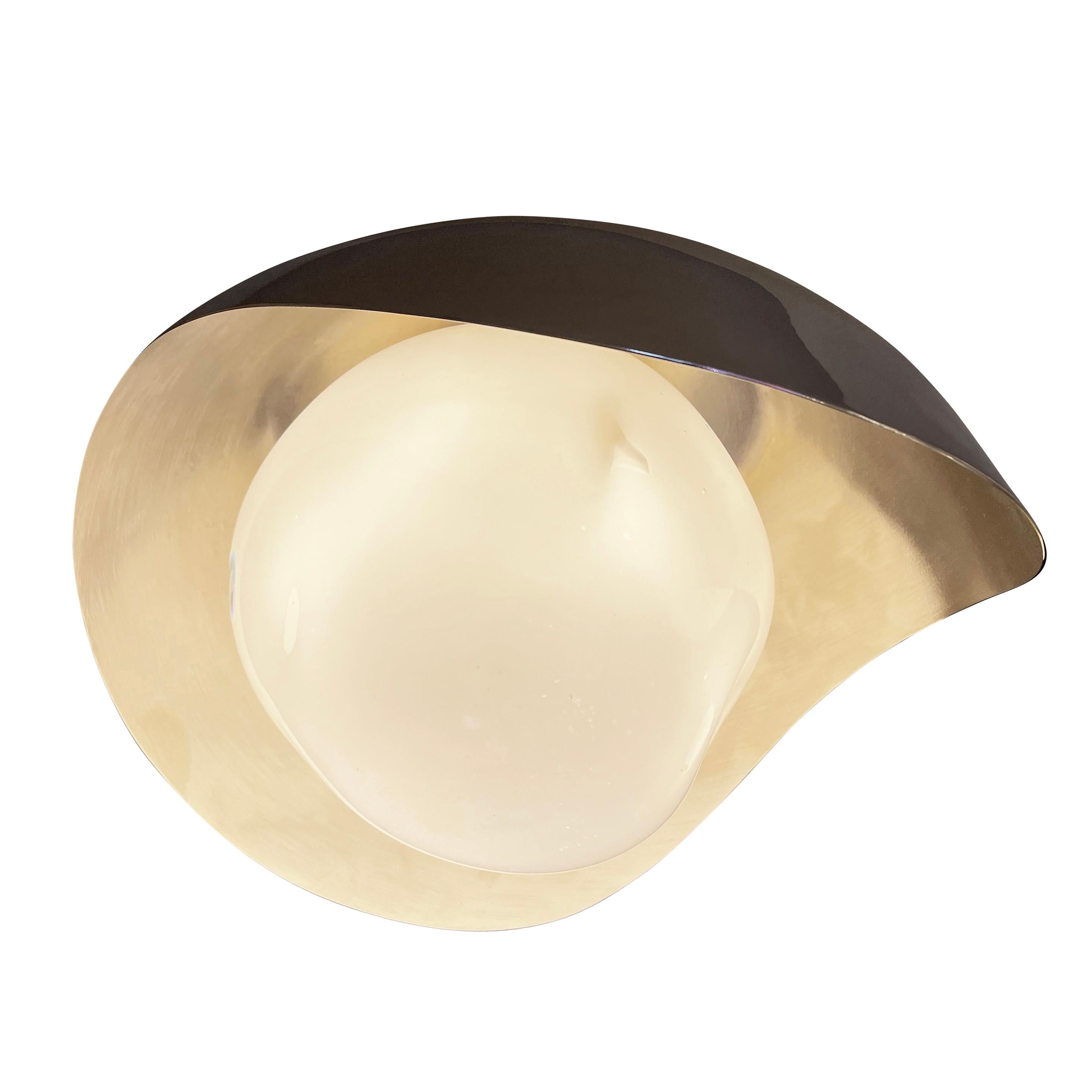 The Perla flush mount features an organic brass shell nestling our sfera glass handblown in Tuscany. Shown in a two-tone finish with a polished nickel exterior and satin nickel interior. Can also be installed as a wall light.

Customization options: